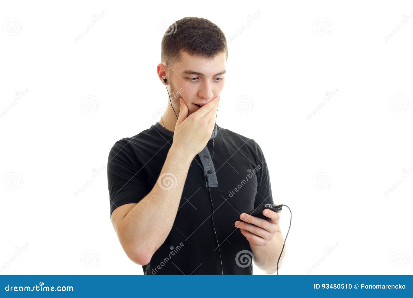 A Young Guy in a Black T-shirt and Looks into the Telephone Headset and ...