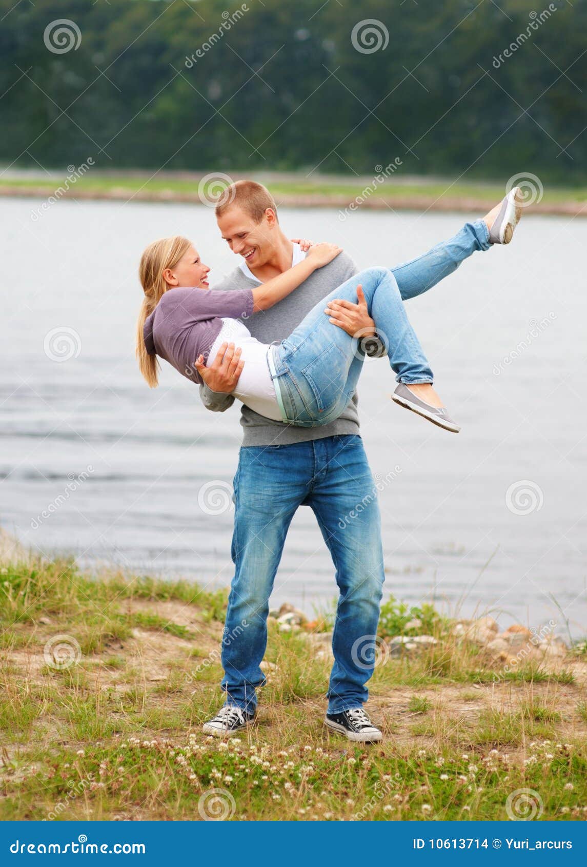 Young Guy Carrying His Girlfriend in His Arms Stoc