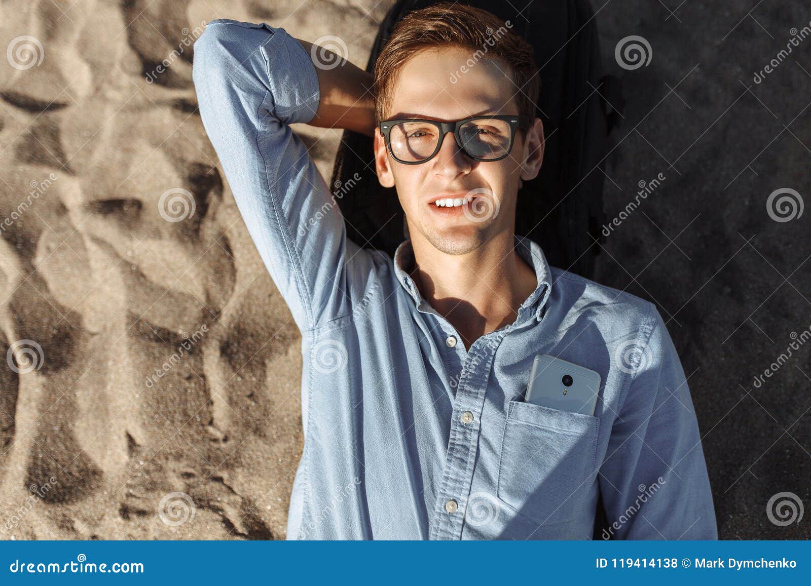 Young Guy with Glasses, Posing, Lying on the Beach on the Sand, Work on ...