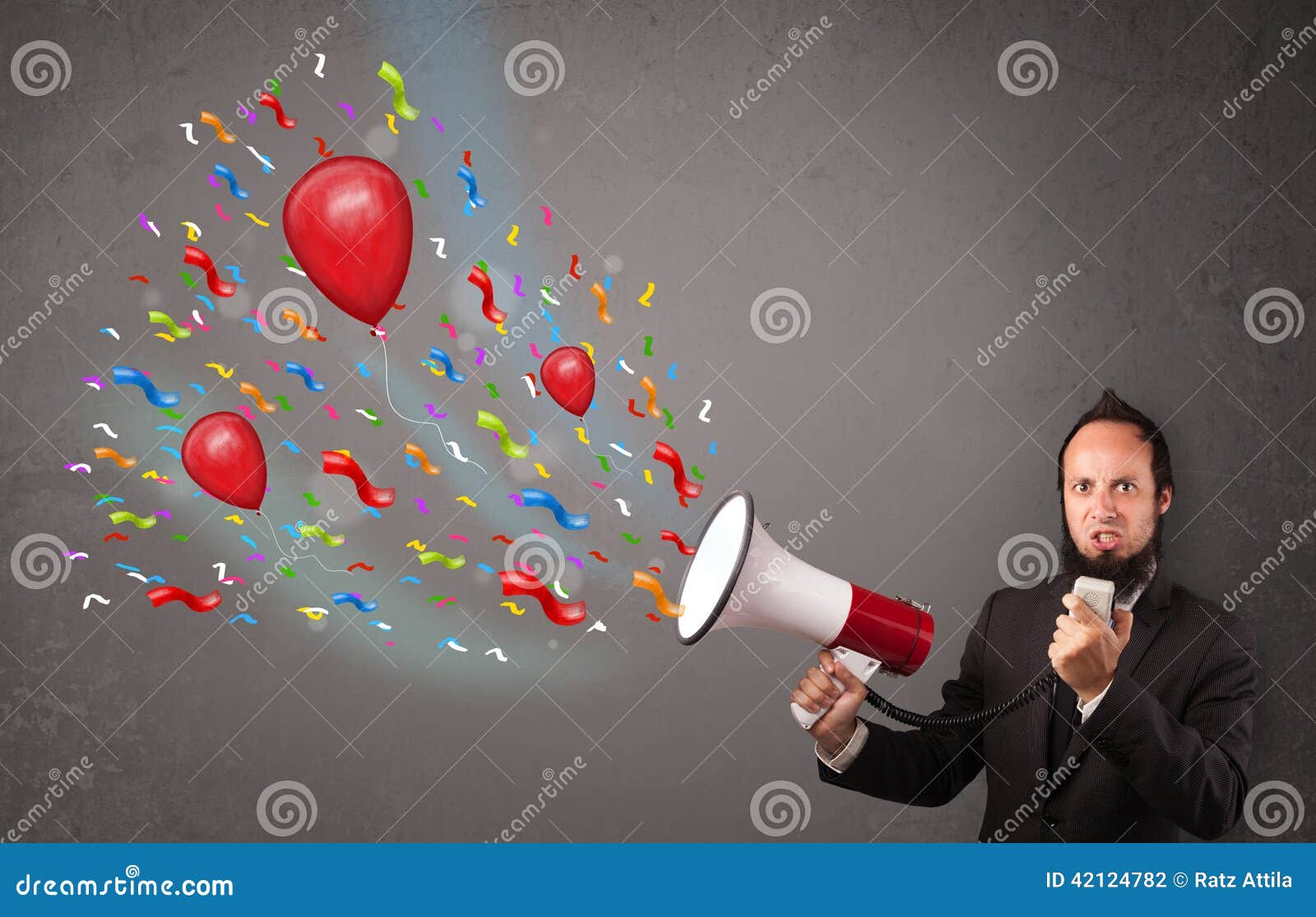 Young Guy Having Fun, Shouting into Megaphone with Balloons Stock Photo