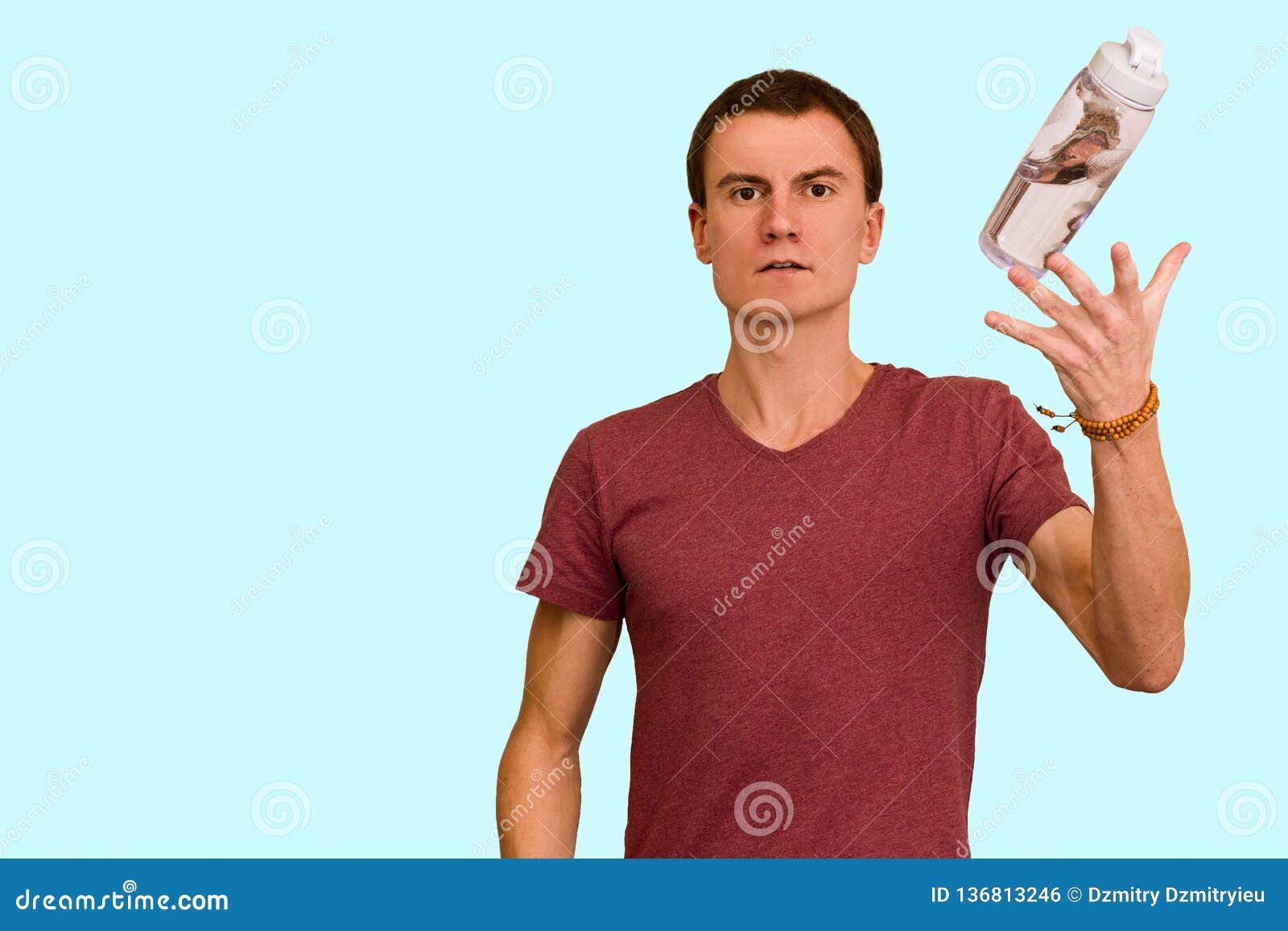 A Young Guy Holds A Bottle Of Water In His Hand Stock Photo I