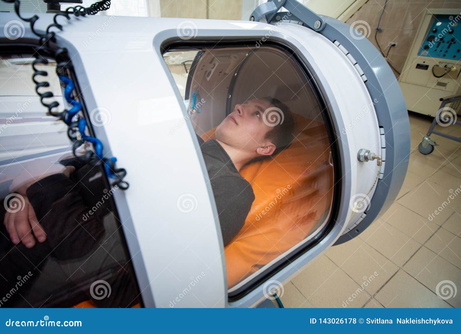 young guy in a hyperbaric chamber, oxygen treatment
