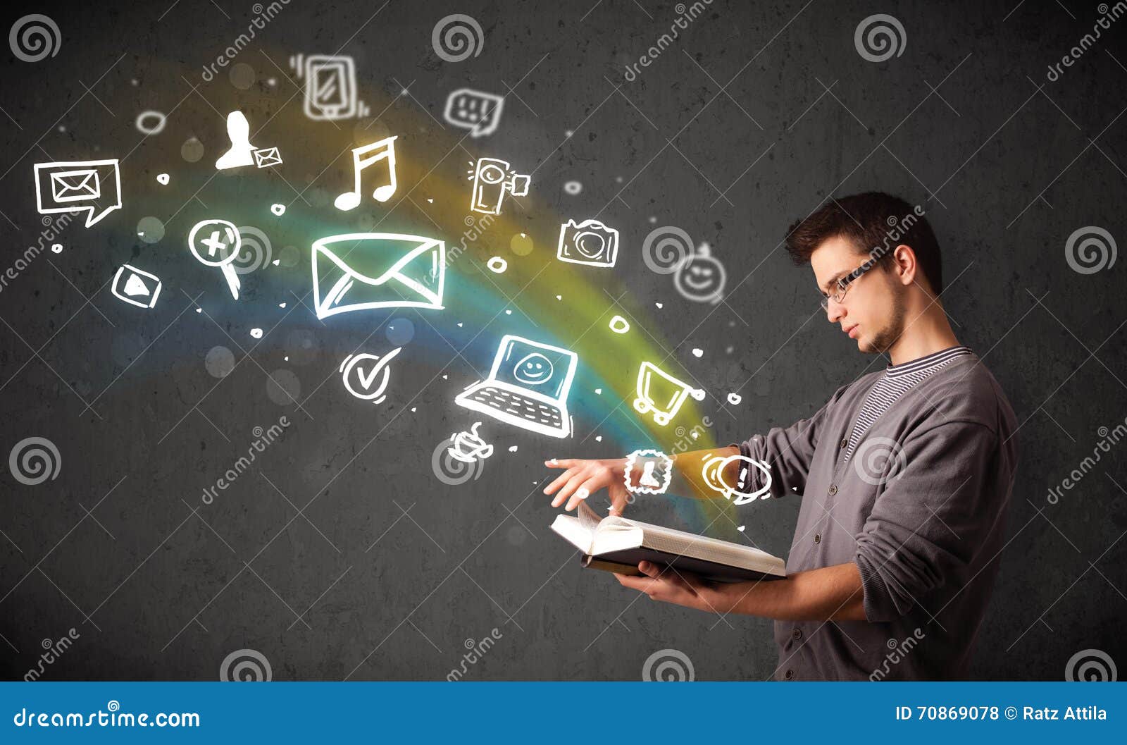 Young Guy Reading a Book with Multimedia Icons Coming Out of the Stock