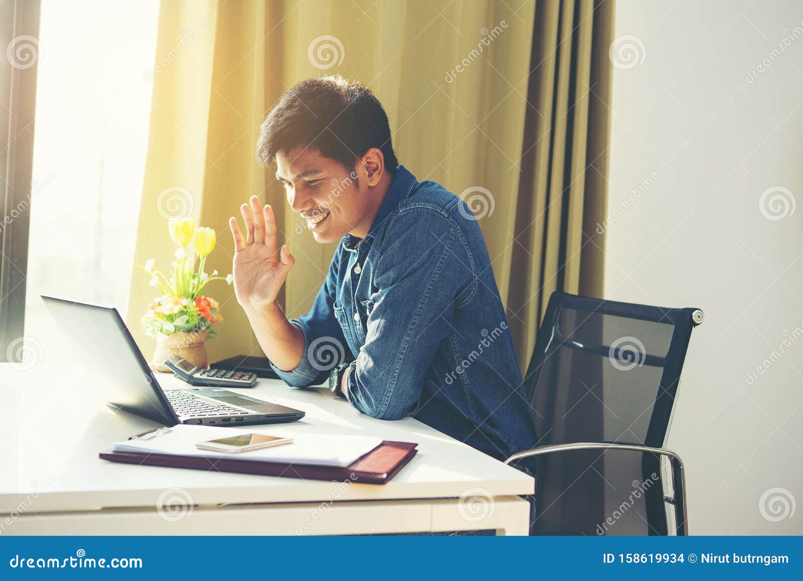young guy start lesson online look at laptop screen wave hand greeting tutor improves foreign language knowledge get skills