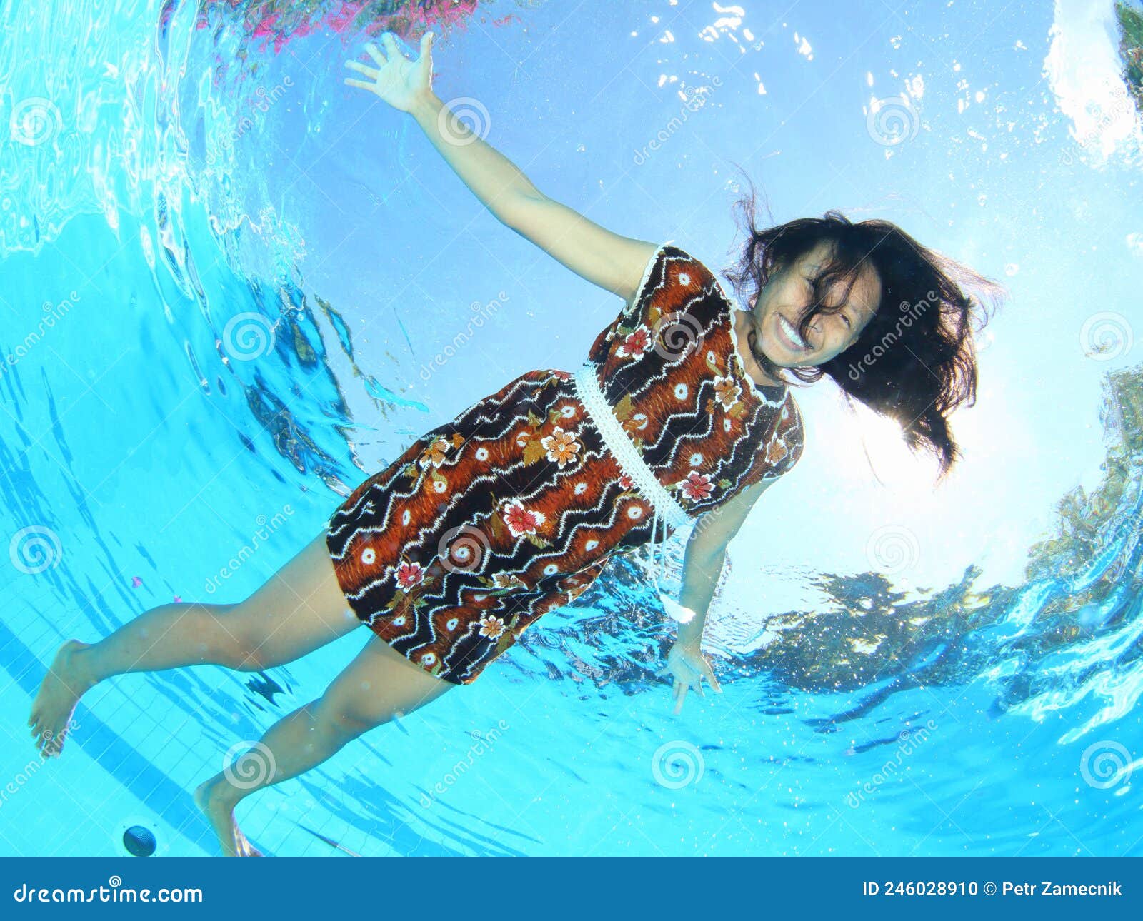 Laughing Papuan Woman Floating in Pool in Brown Dress Stock Photo ...