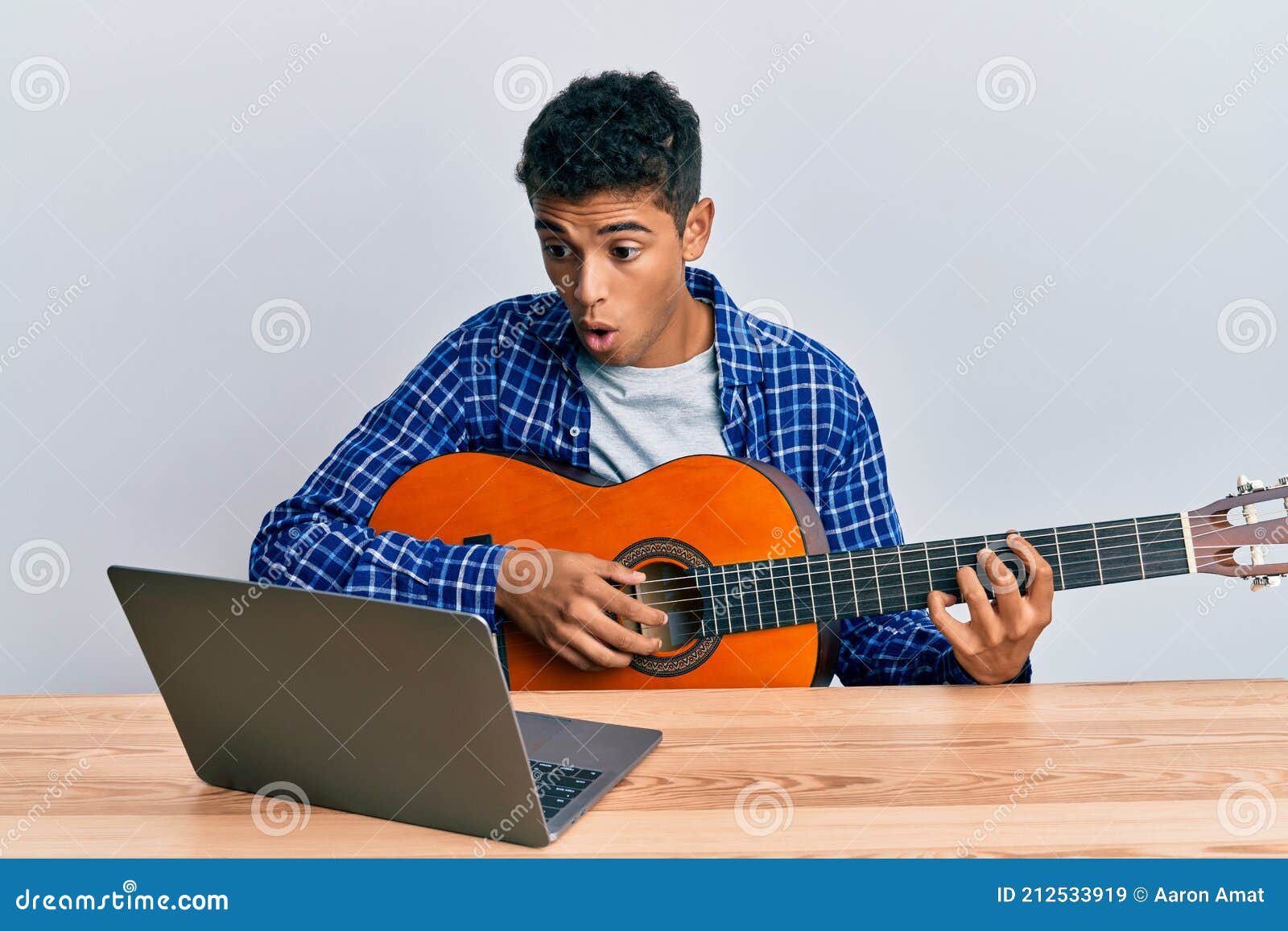 Young Handsome African American Man Learning Classical Guitar from