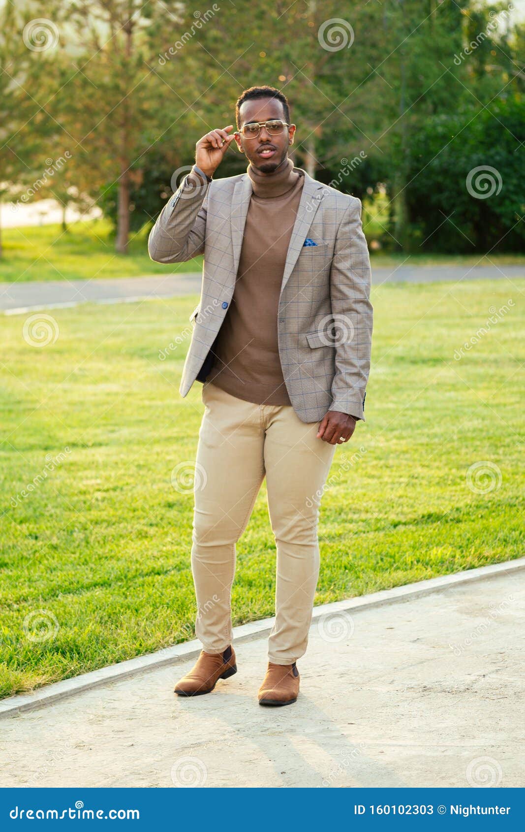 A Young and Handsome African American Man in a Stylish Suit in a Summer ...