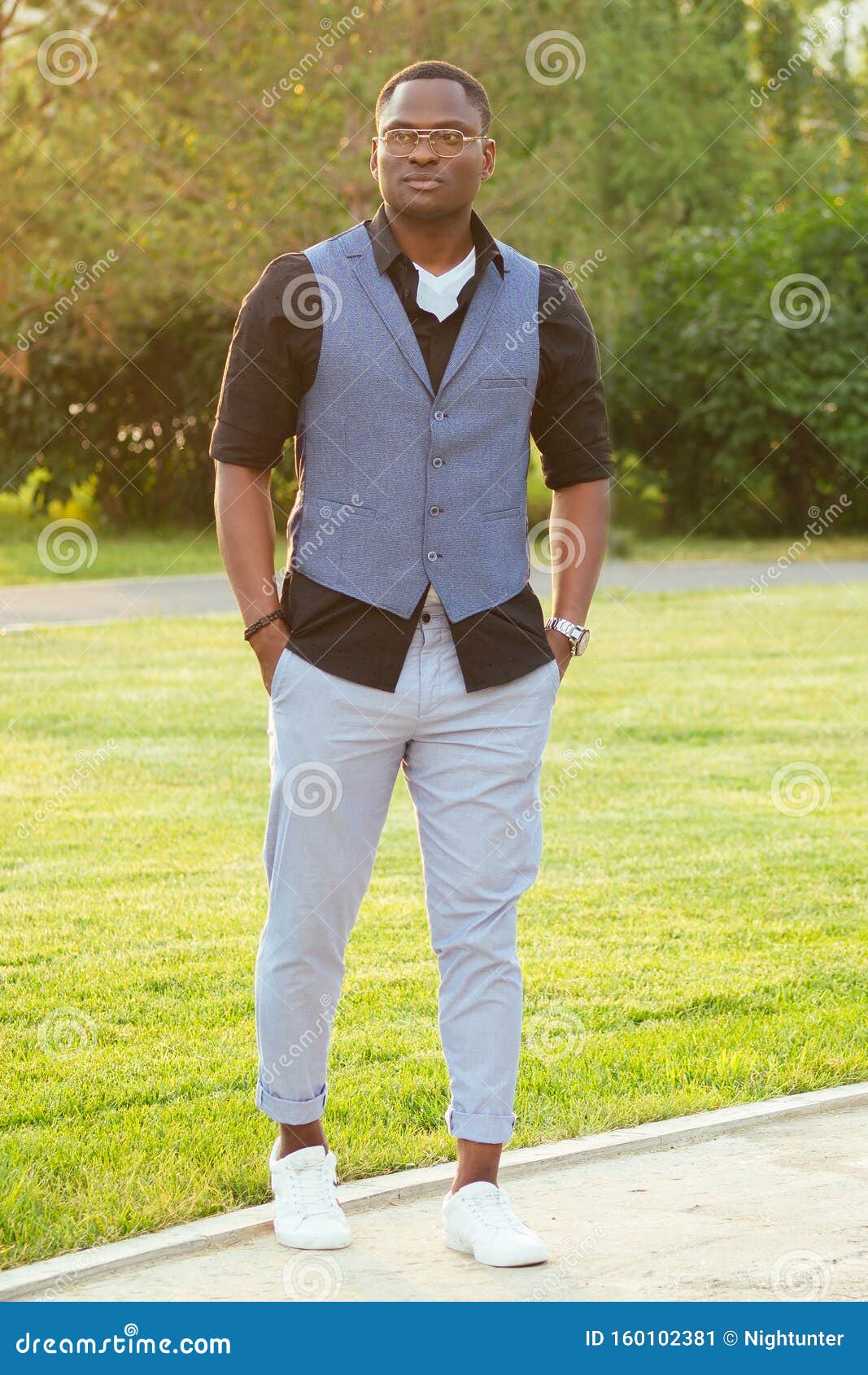 A Young and Handsome African American Man in a Stylish Suit in a Summer ...