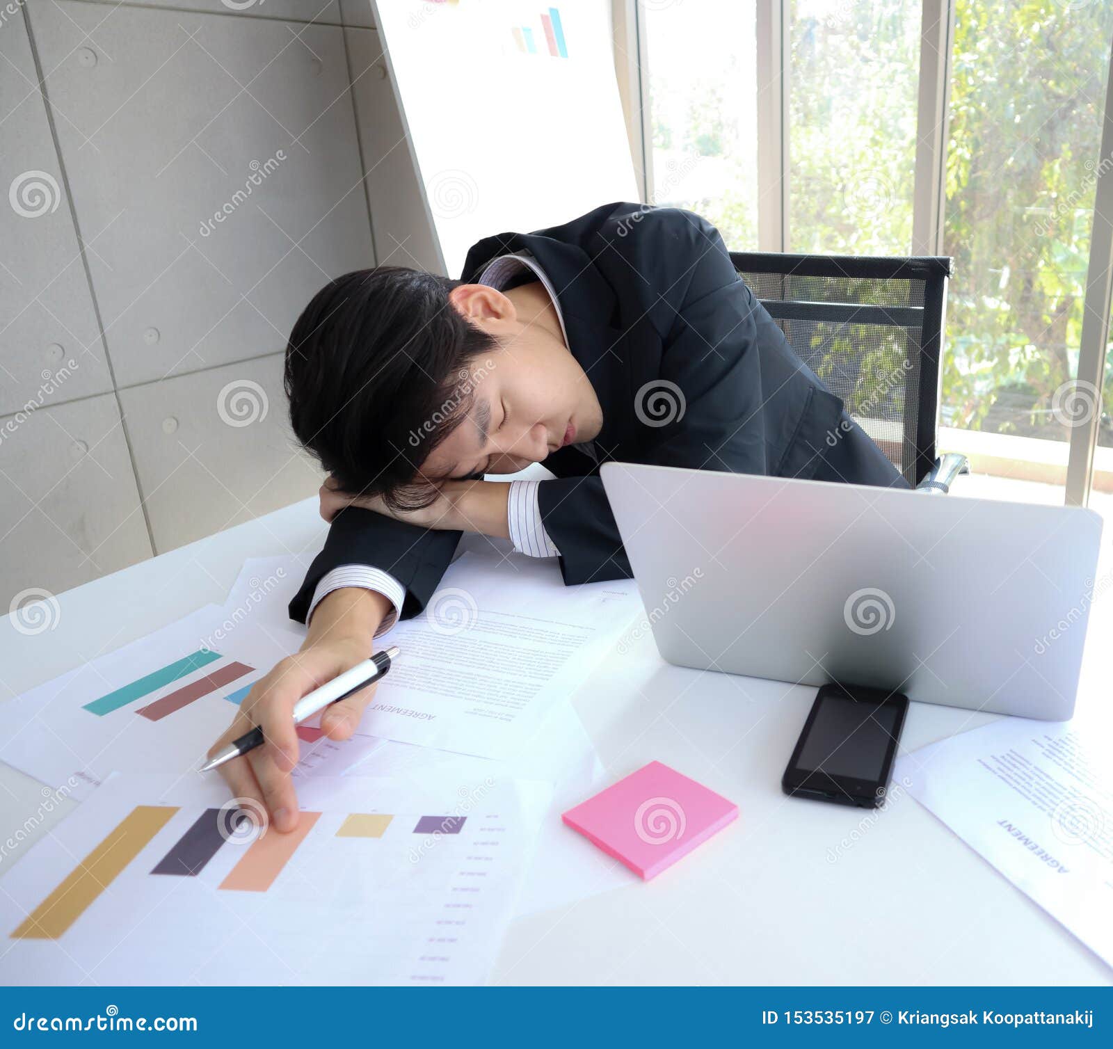 Young Handsome Asian Business Man Fall Asleep On The Working Desk