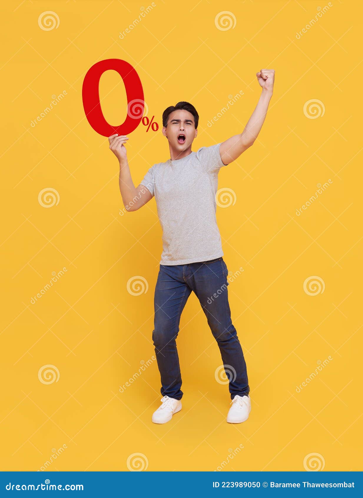 young handsome asian man holding up to 0% and happy celebrating on yellow background for no interest installment payment concept