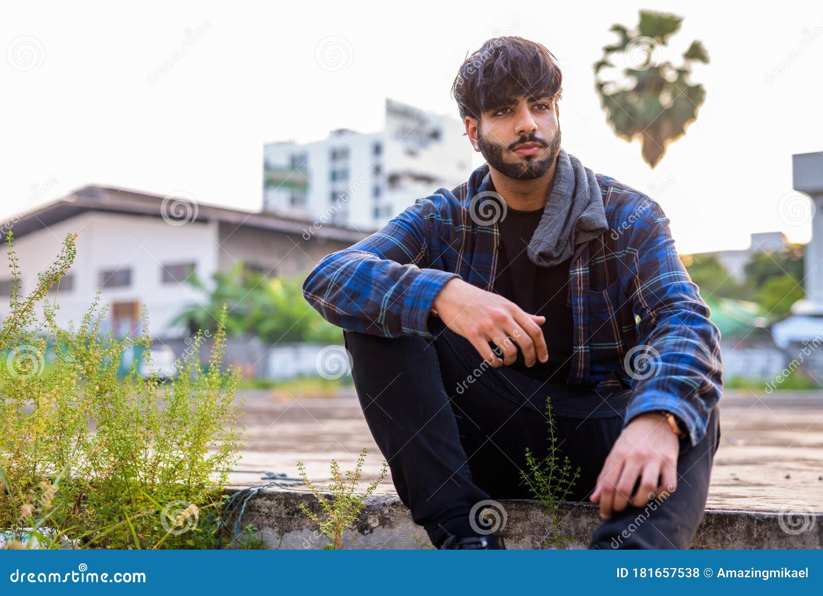 Young Handsome Bearded Indian Hipster Man Sitting in Urban Streets ...