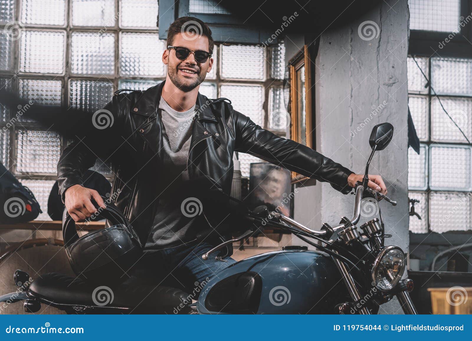 Young Handsome Biker in Black Leather Jacket with Classic Motorcycle ...