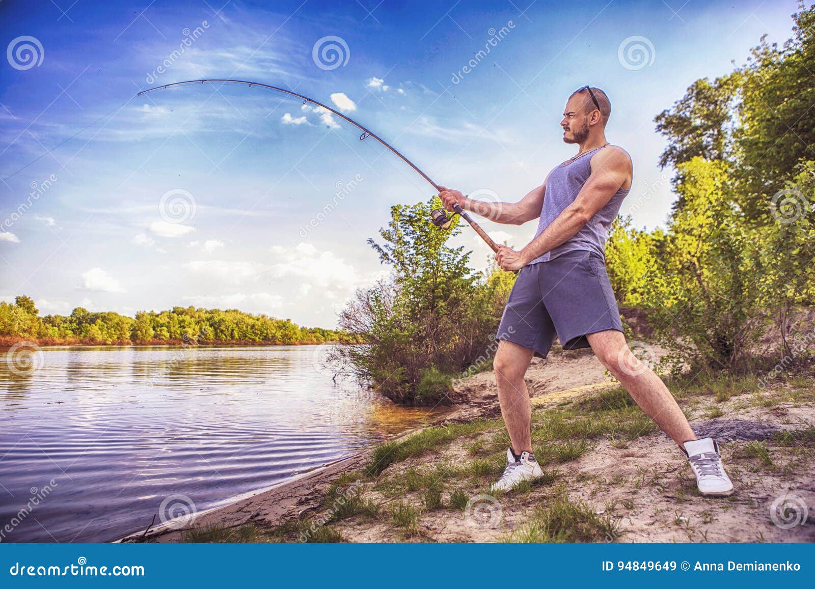 Young Handsome Brutal Caucasian Man in Casual Outfit Fishing on