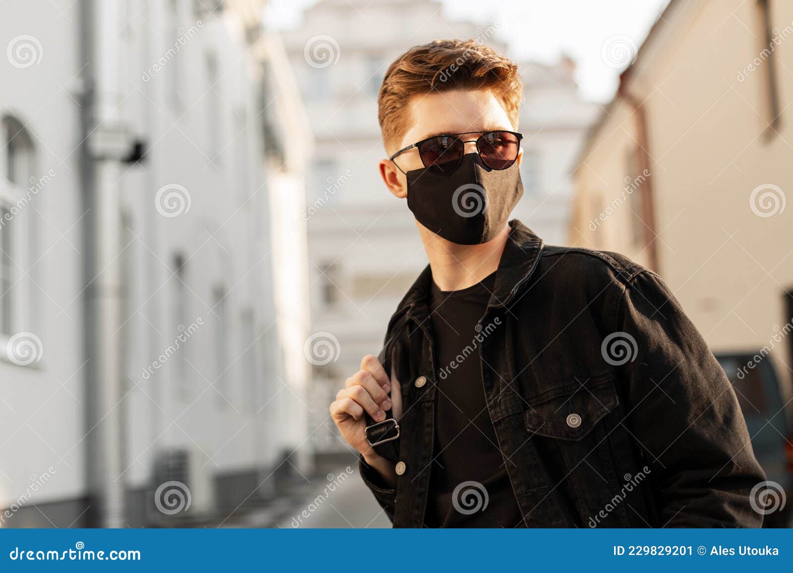 Young Handsome Fashion Man in Sunglasses with Backpack in Face