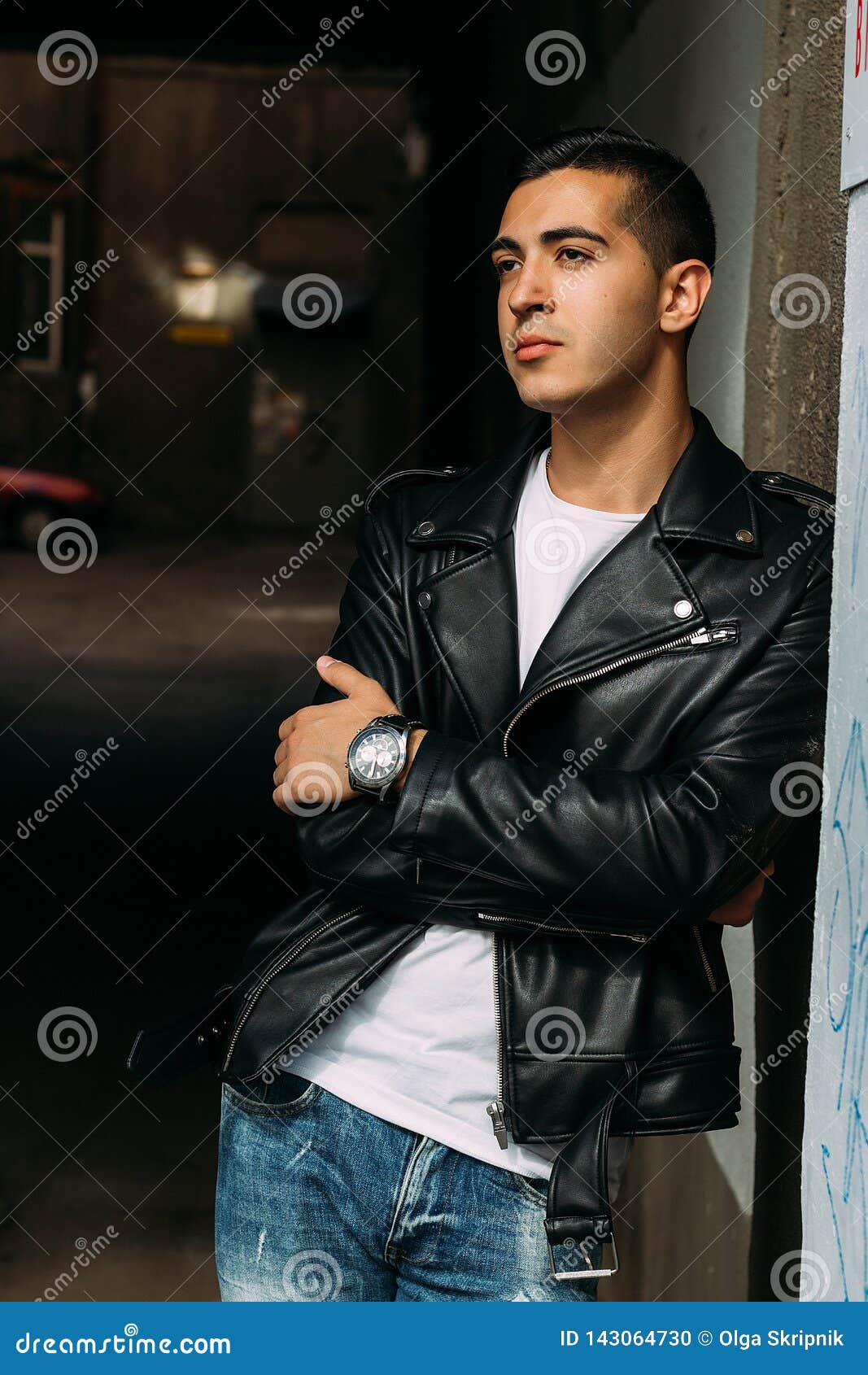 Young, Handsome Guy in a White T-shirt, Black, Leather Jacket and Blue ...