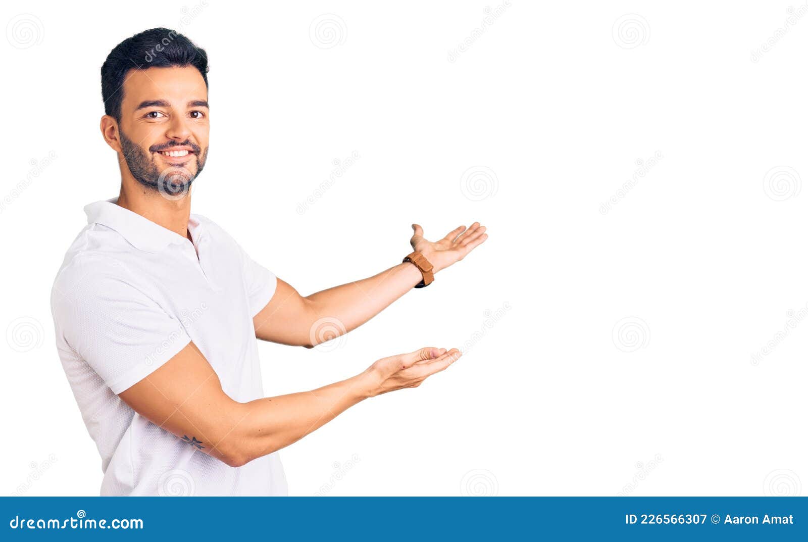 young handsome hispanic man wearing casual clothes inviting to enter smiling natural with open hand