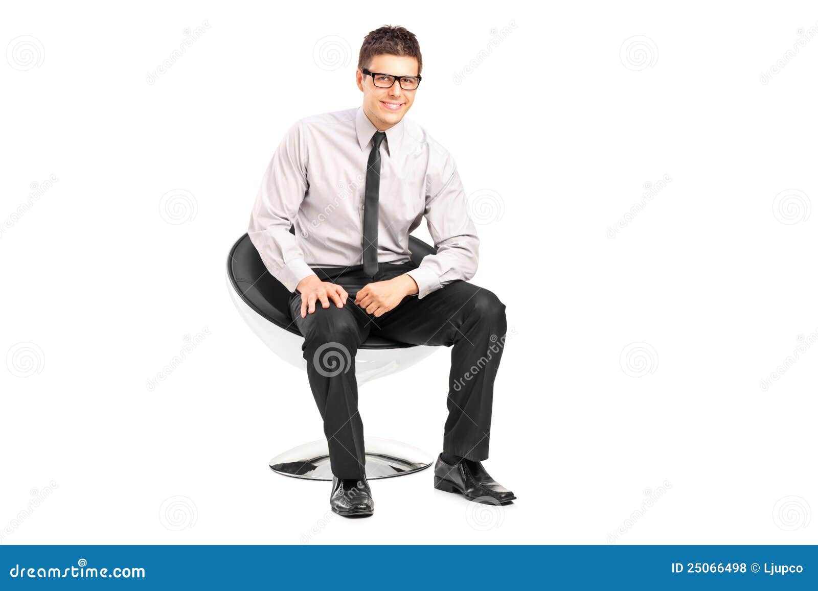 A young handsome male sitting on a chair on white background