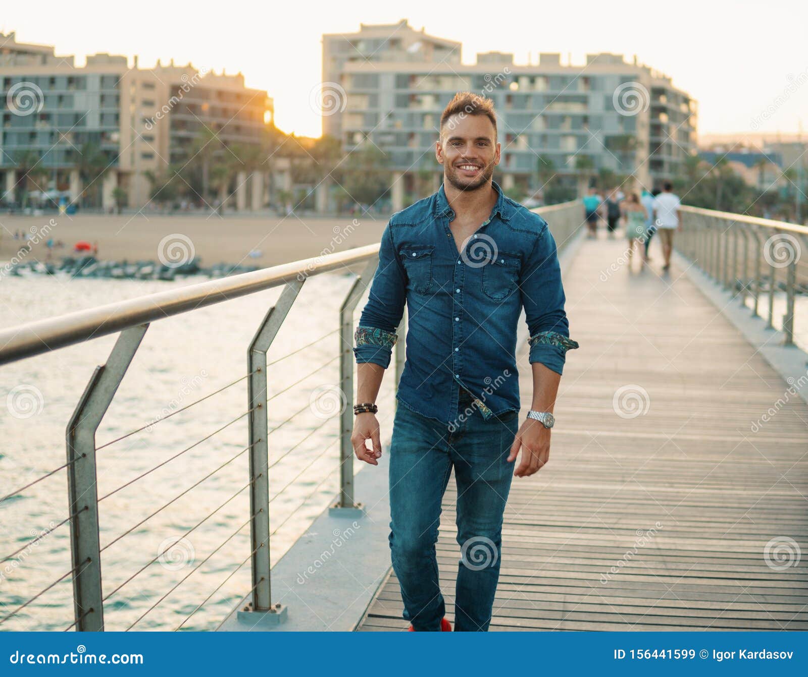A Young Handsome Man on the Bridge Near Beautiful Beach. Stock Image ...