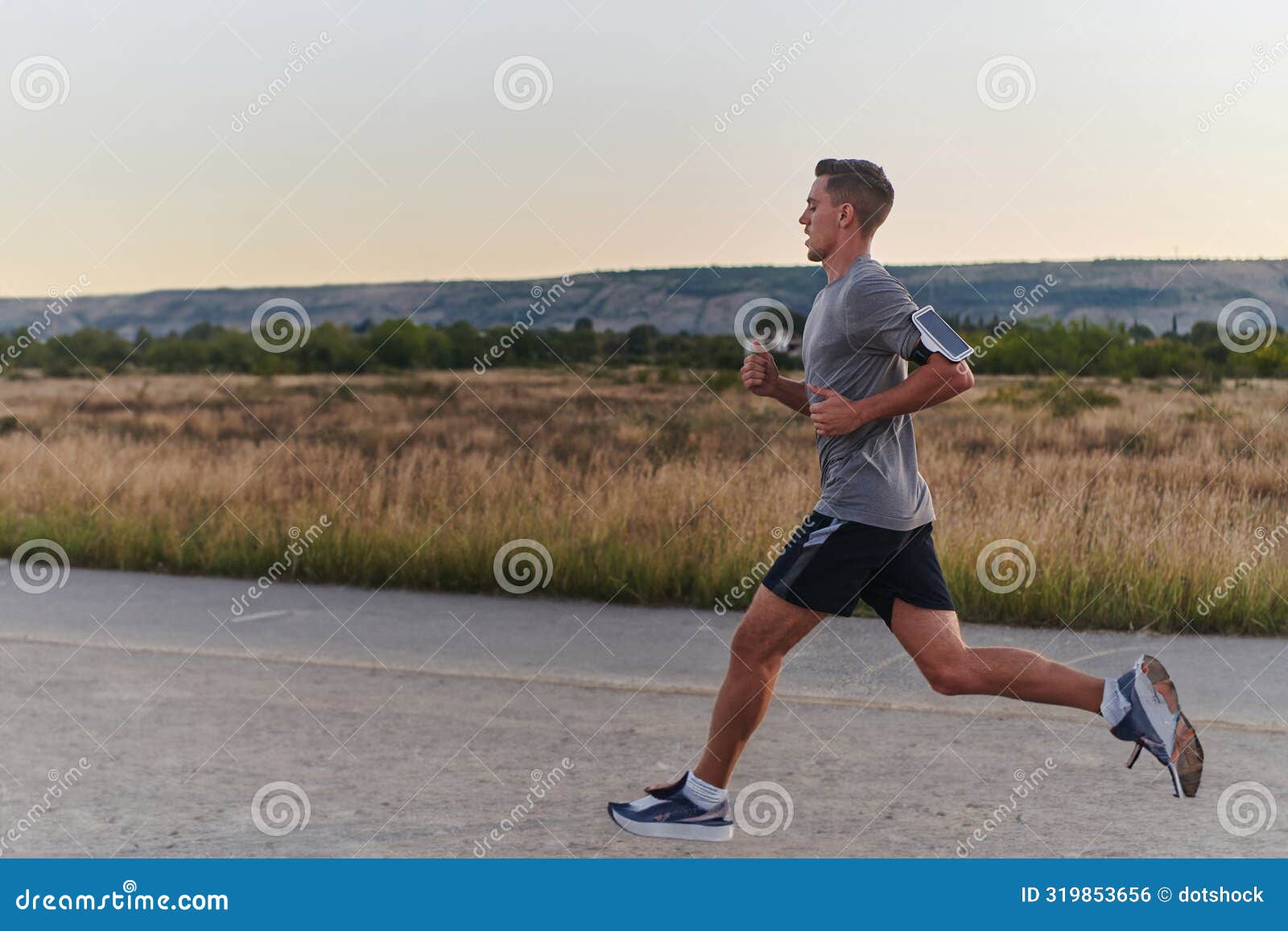 a young handsome man running in the early morning hours, driven by his commitment to health and fitness