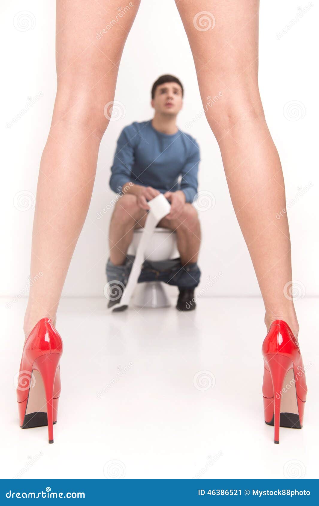 Young Handsome Man Sitting on Toilet