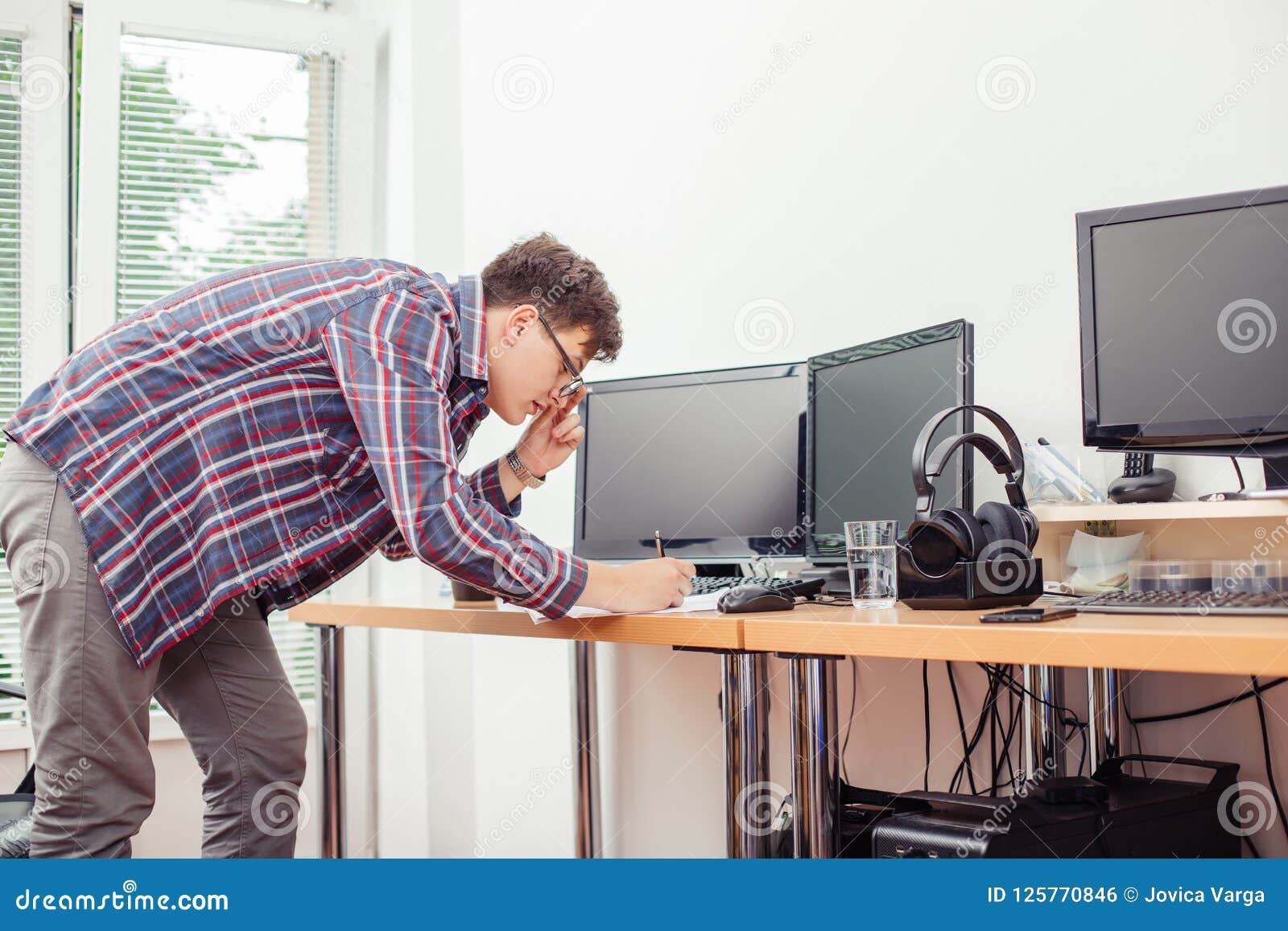 Man Writing Documents at Office Desk Stock Photo Image of paper