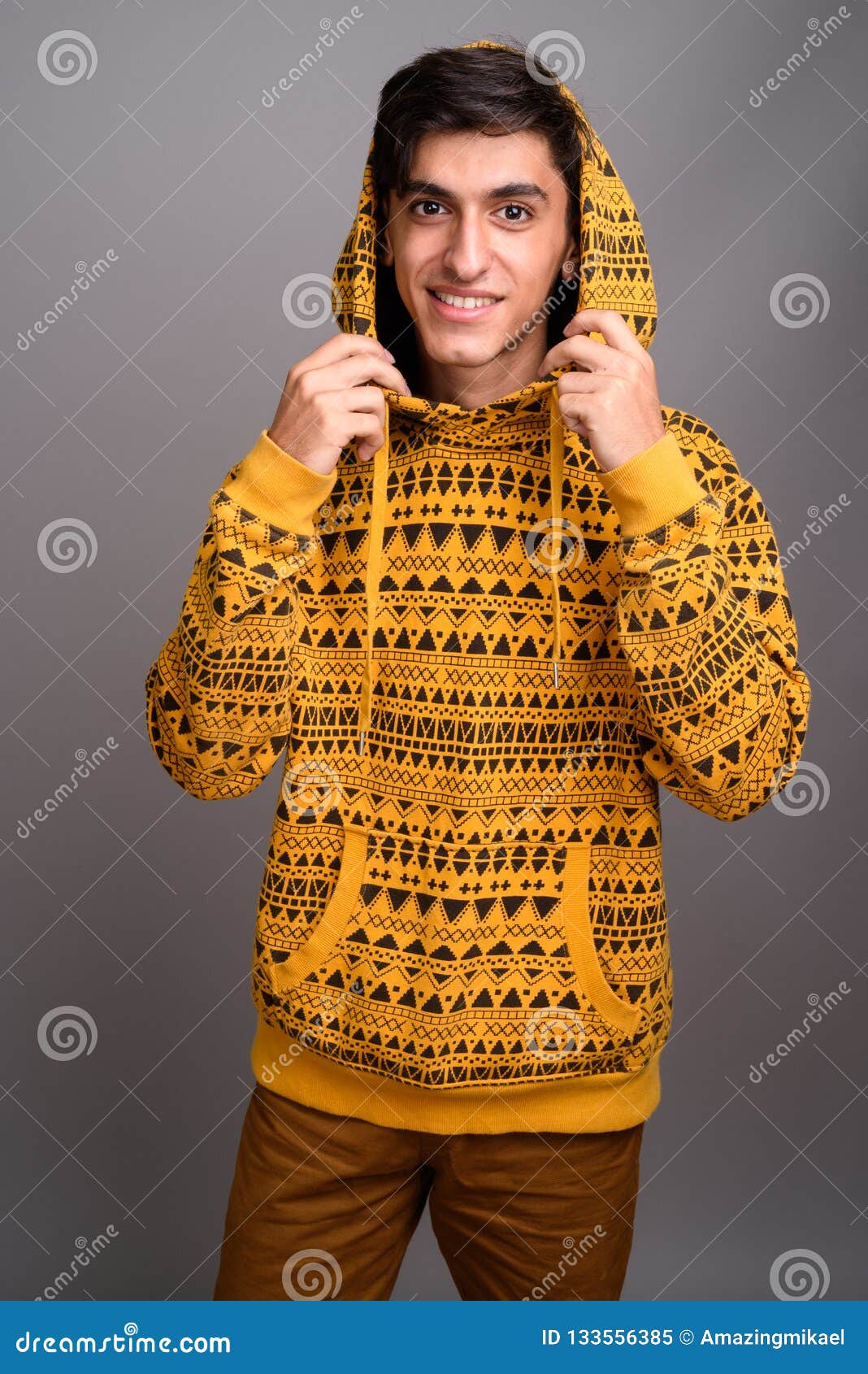 Young Handsome Persian Teenage Boy Against Gray Background Stock Image ...