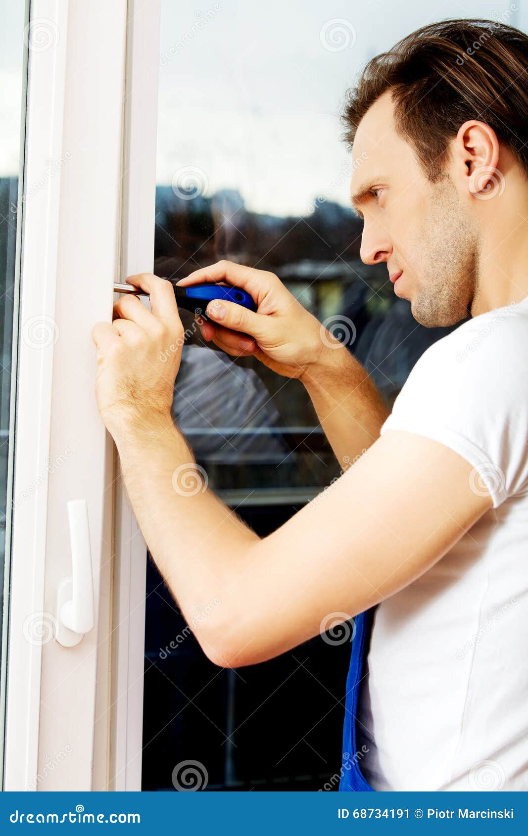 Young Handyman Repair Window with Screwdriver Stock Image Image of