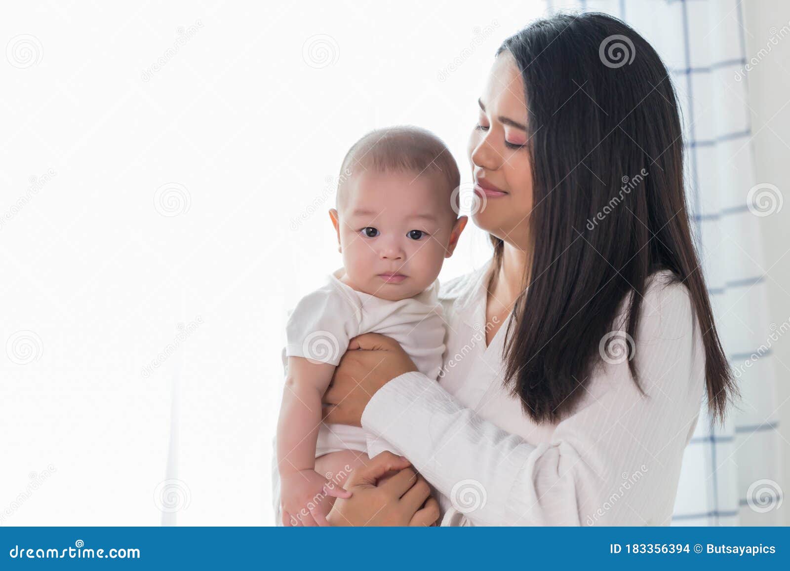 Young Happy Asian Mom And Newborn Baby Infant Son Playi