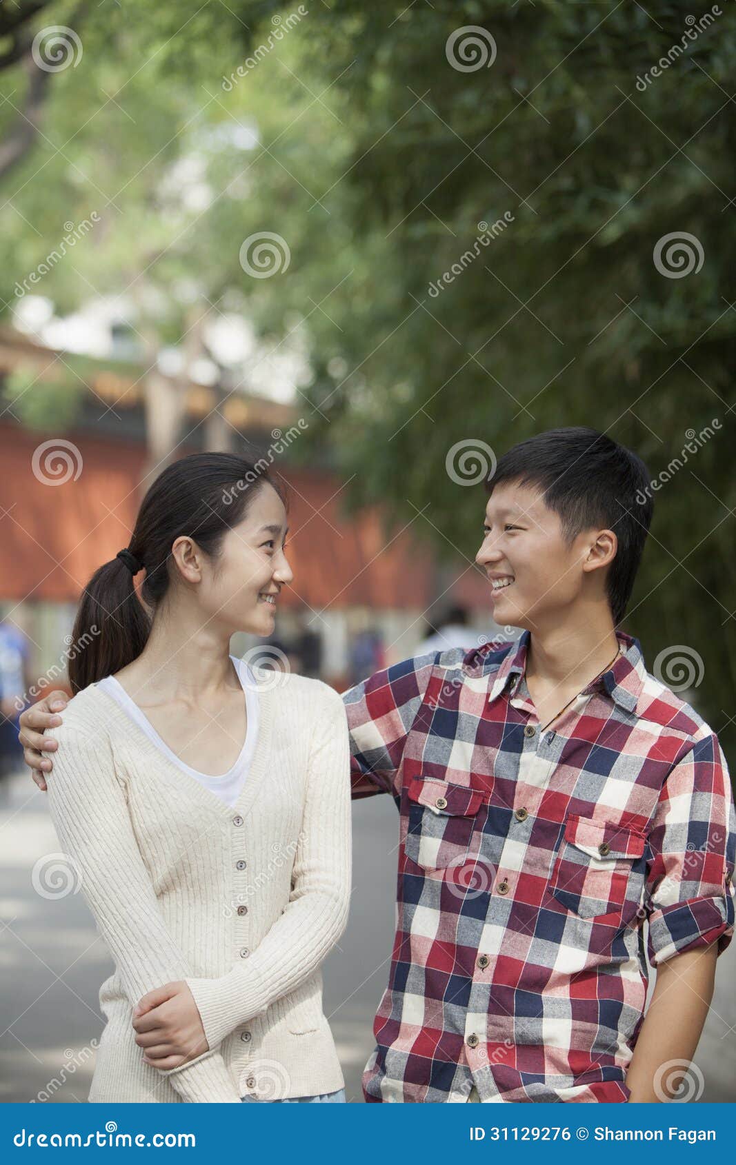 young happy chinese couple walking in jing shan park