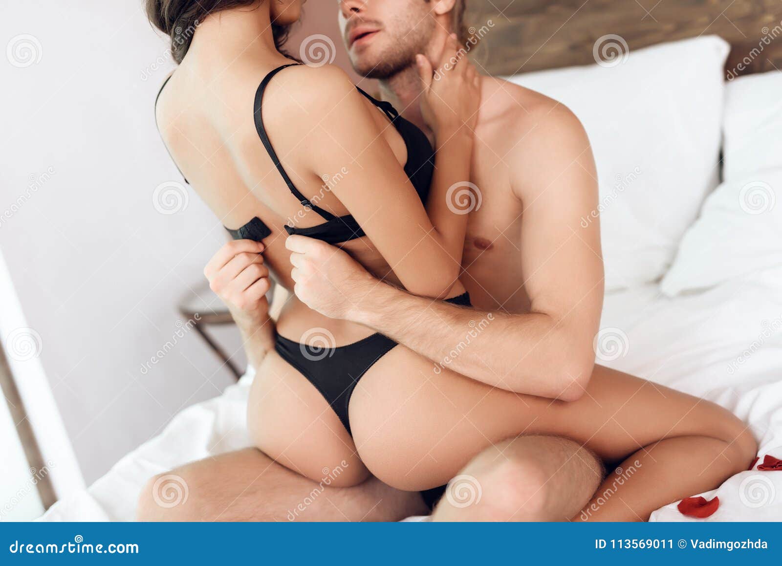 Young horny couple having romantic sex on the bed