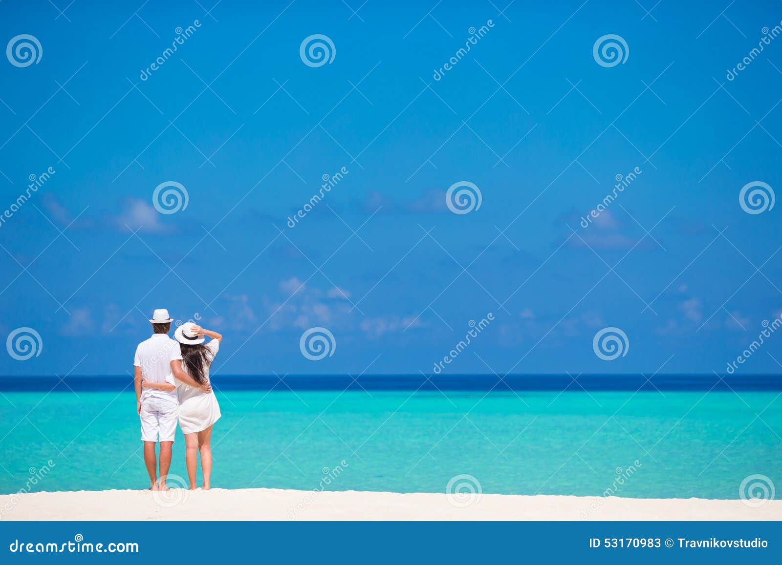 young happy couple on white beach at summer