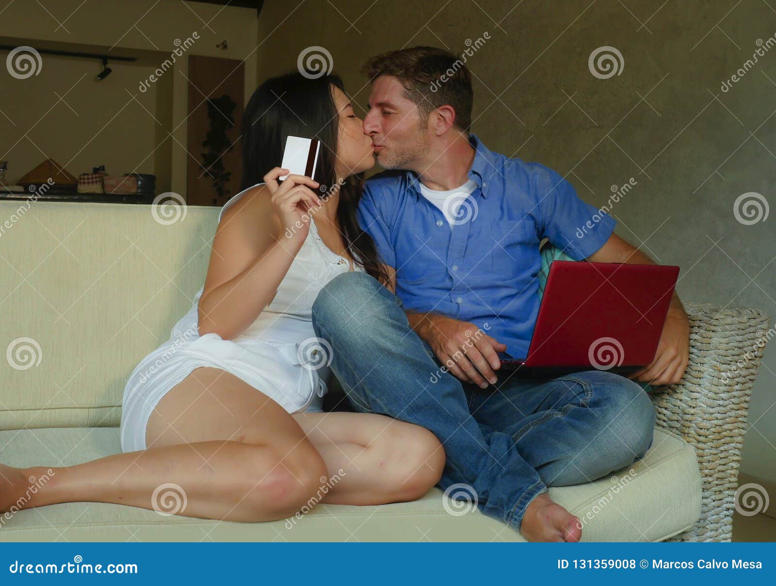 Young Happy and Excited Mixed Ethnicity Couple with Asian Chinese Woman and White Man Internet Banking and Online Shopping with Cr Stock Photo