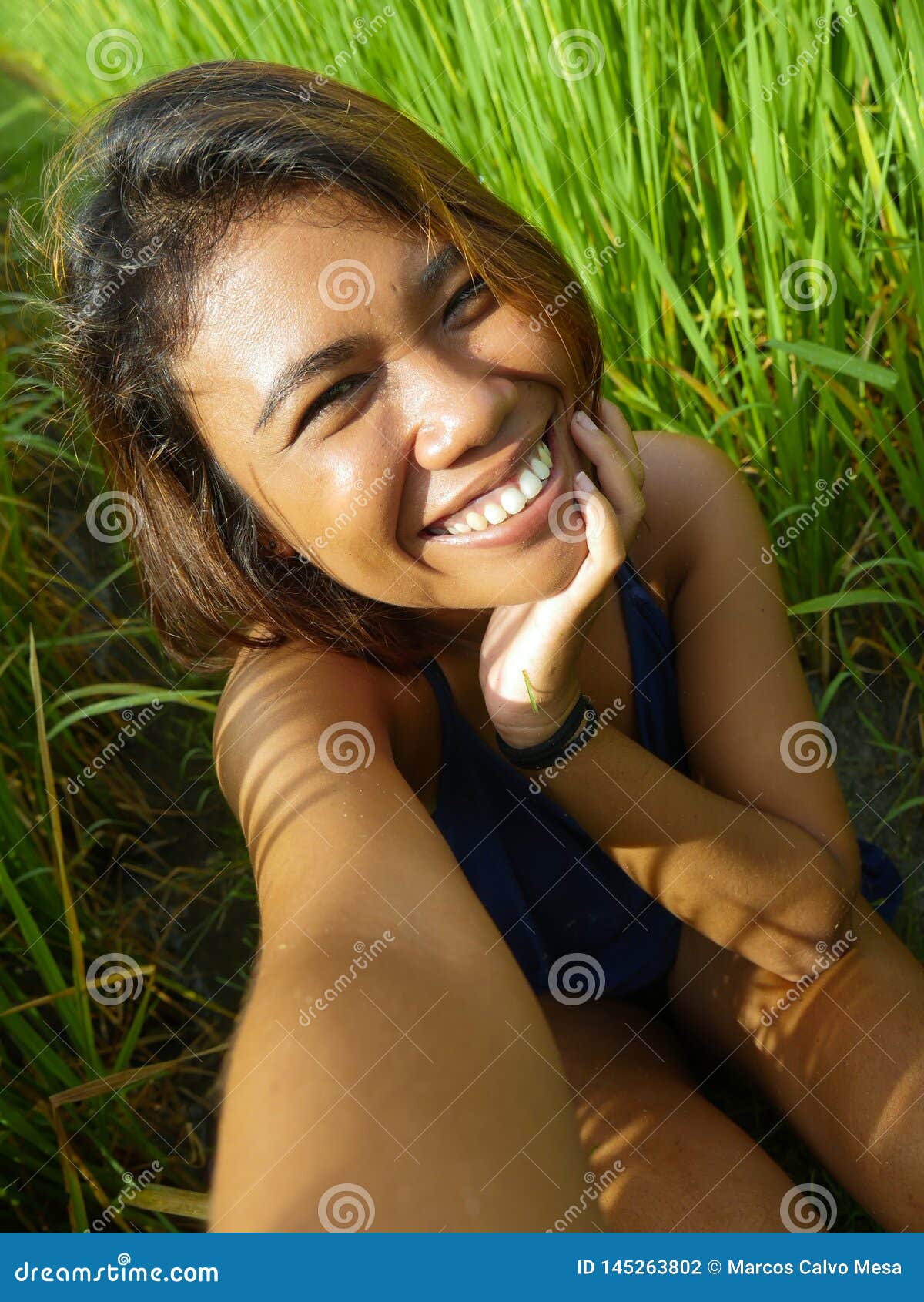 Young Happy And Exotic Islander Asian Girl From Indonesia Taking Selfie 
