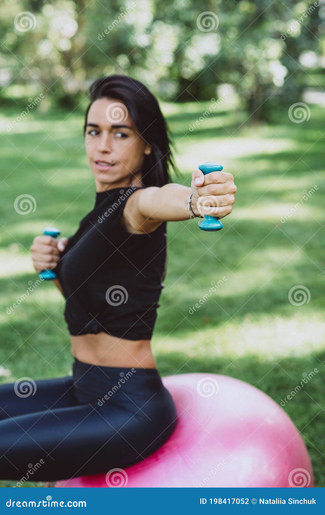 Young Happy Fit Tanned Brunette Goes In For Sports With A Big Fitness Ball Dressed In Active