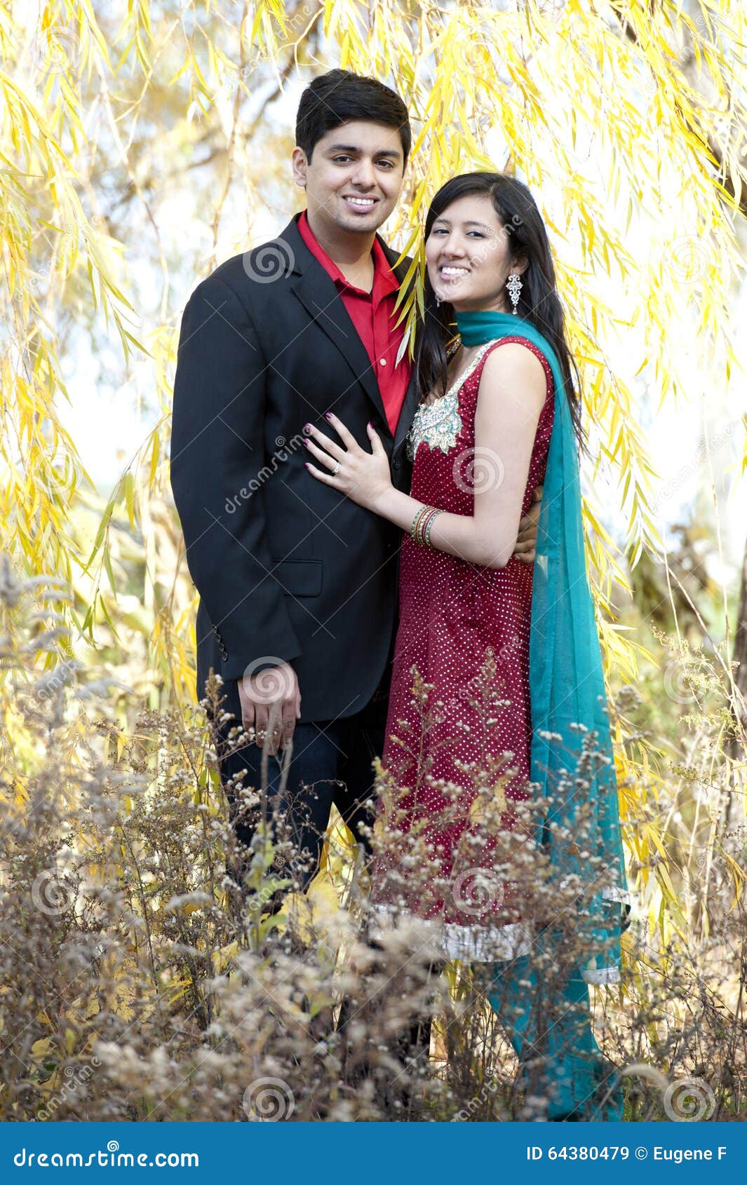 Indian couple posing out doors for sangeet photo session. | Photo 296138