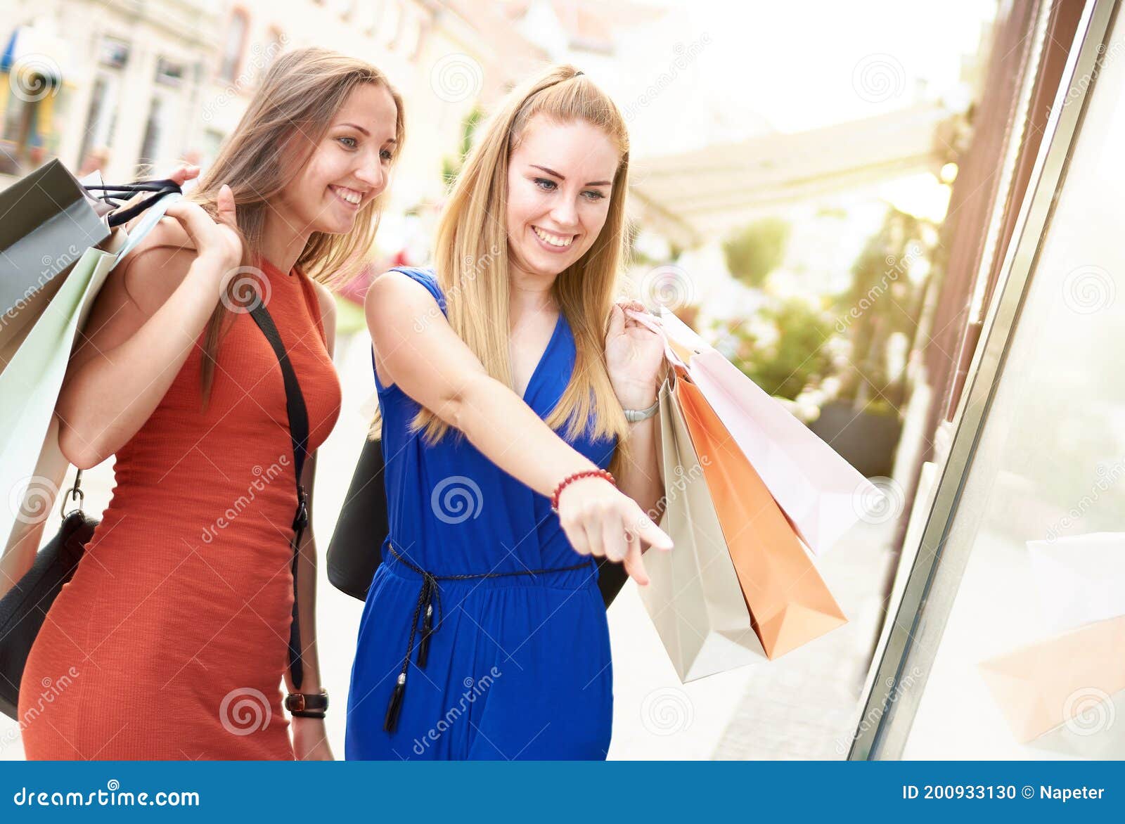 Young Happy Millennial Women Friends with Colorful Paper Shopping Bags ...