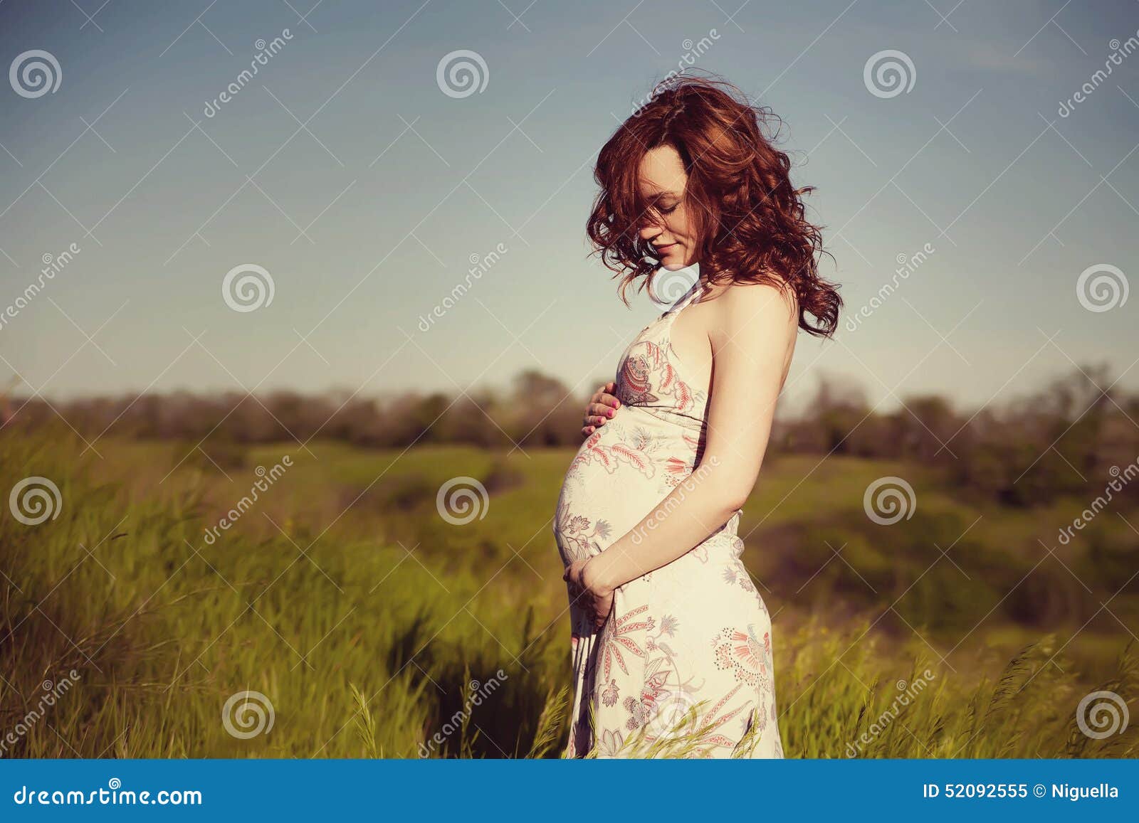 young happy pregnant woman relaxing and enjoying life in nature.
