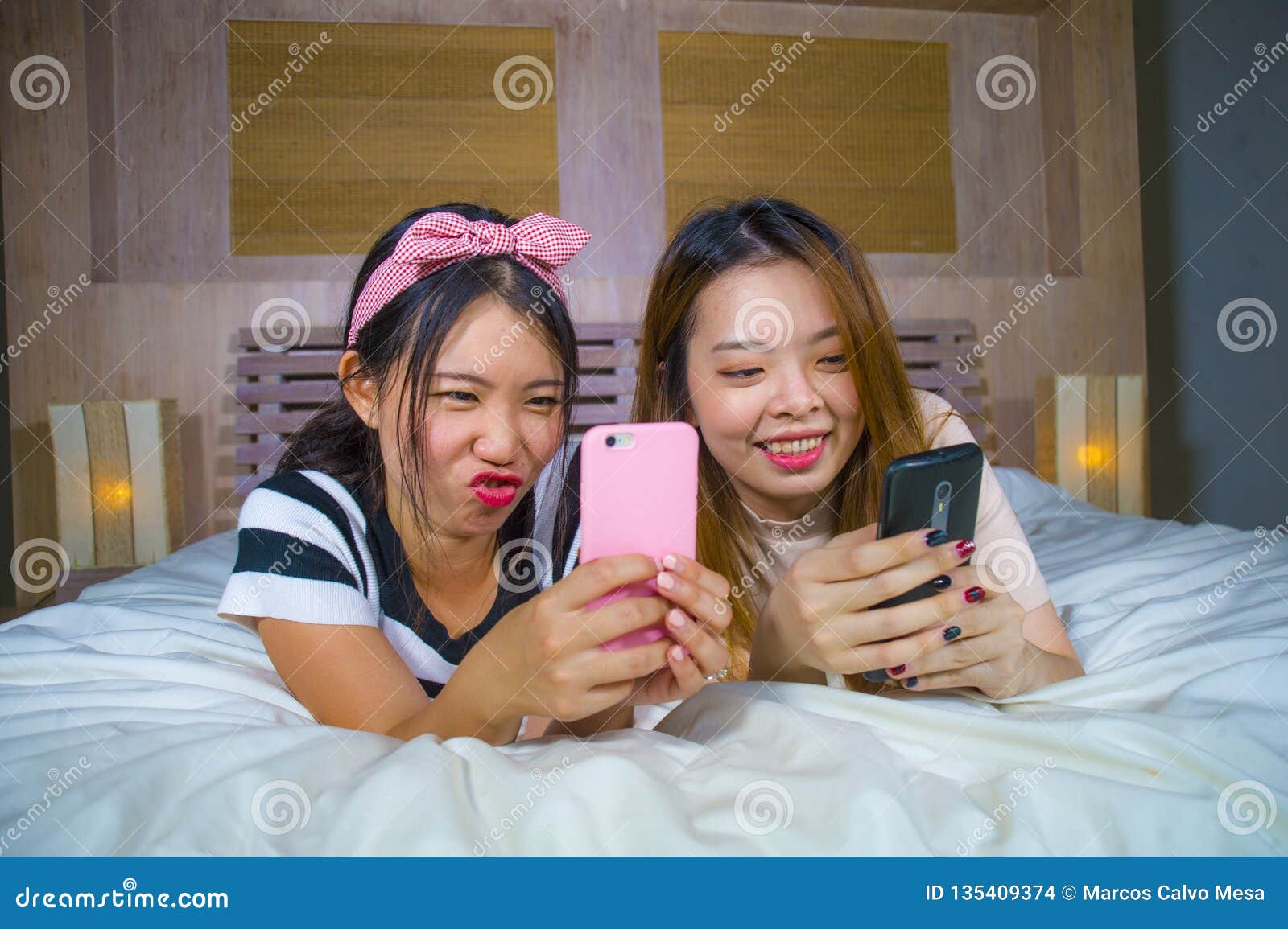 https://thumbs.dreamstime.com/z/young-happy-pretty-asian-chinese-girlfriends-sitting-home-bedroom-laughing-talking-having-fun-using-internet-social-two-135409374.jpg