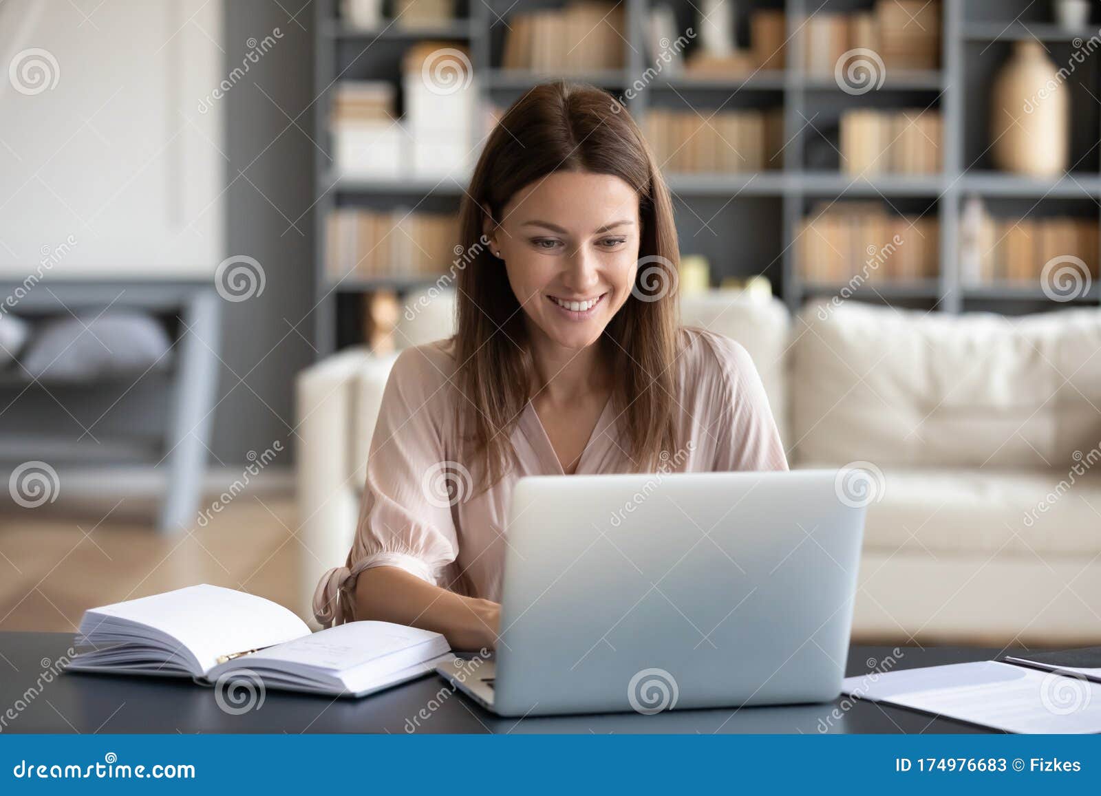 young happy woman working on computer at home.