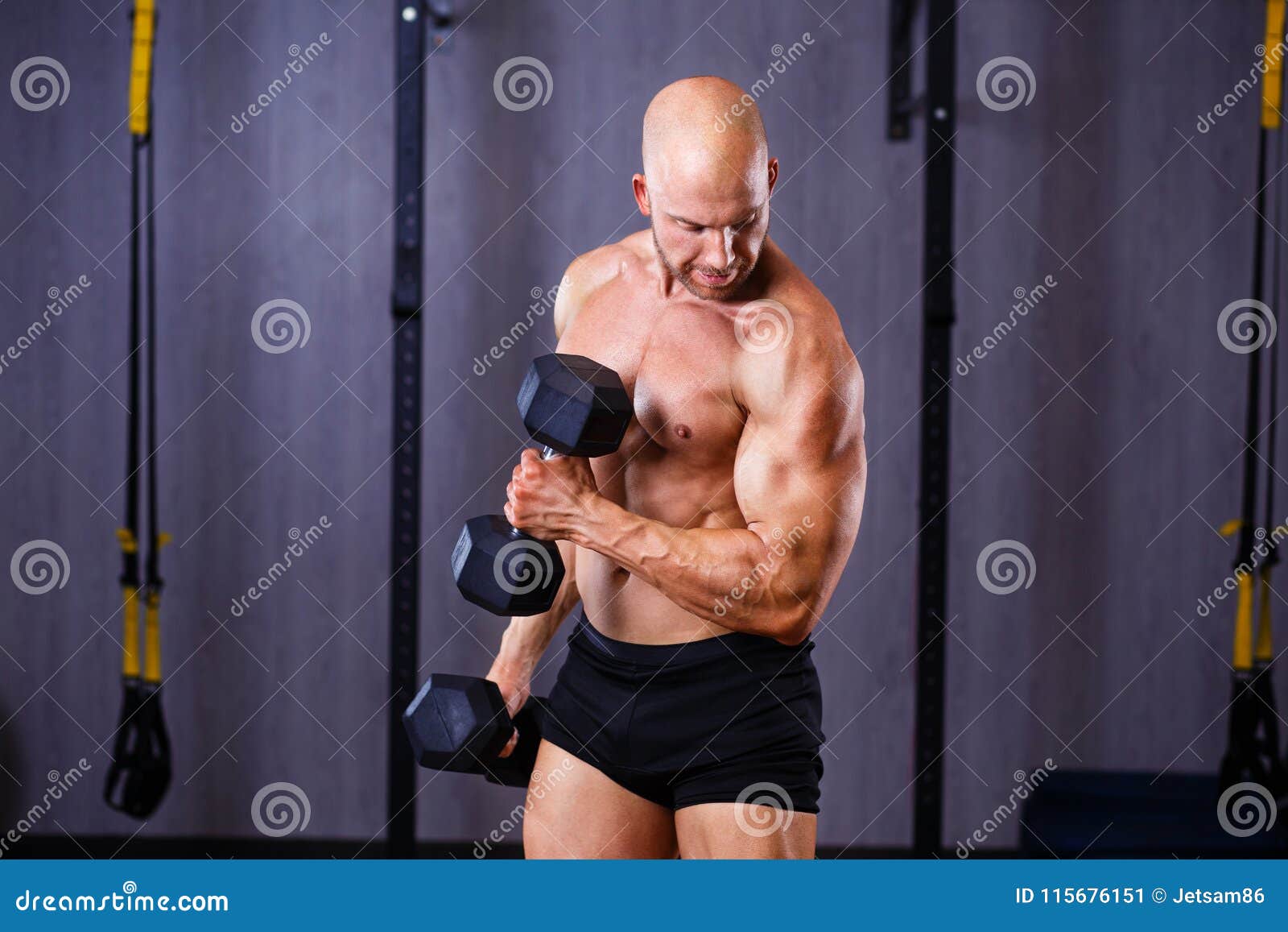 Young Healthy Bald Ripped Man with Big Muscles Training with Dum Stock ...