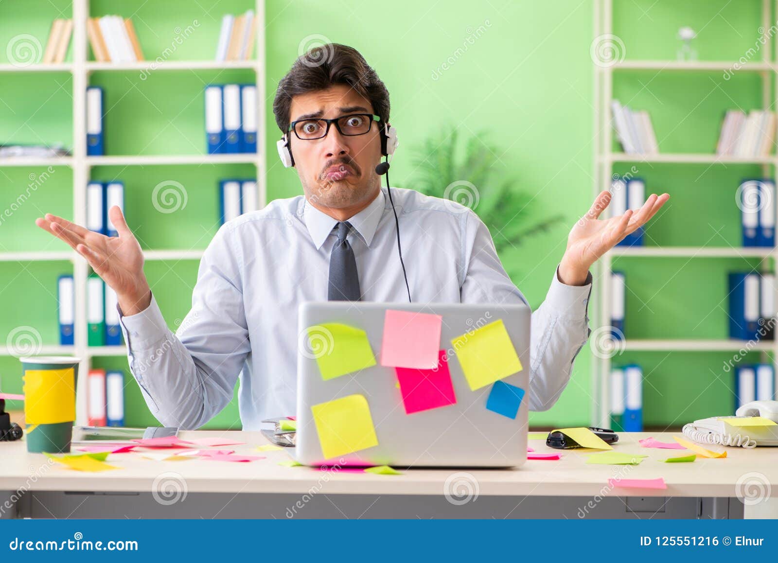 Young Help Desk Operator Working In Office With Many Conflicting