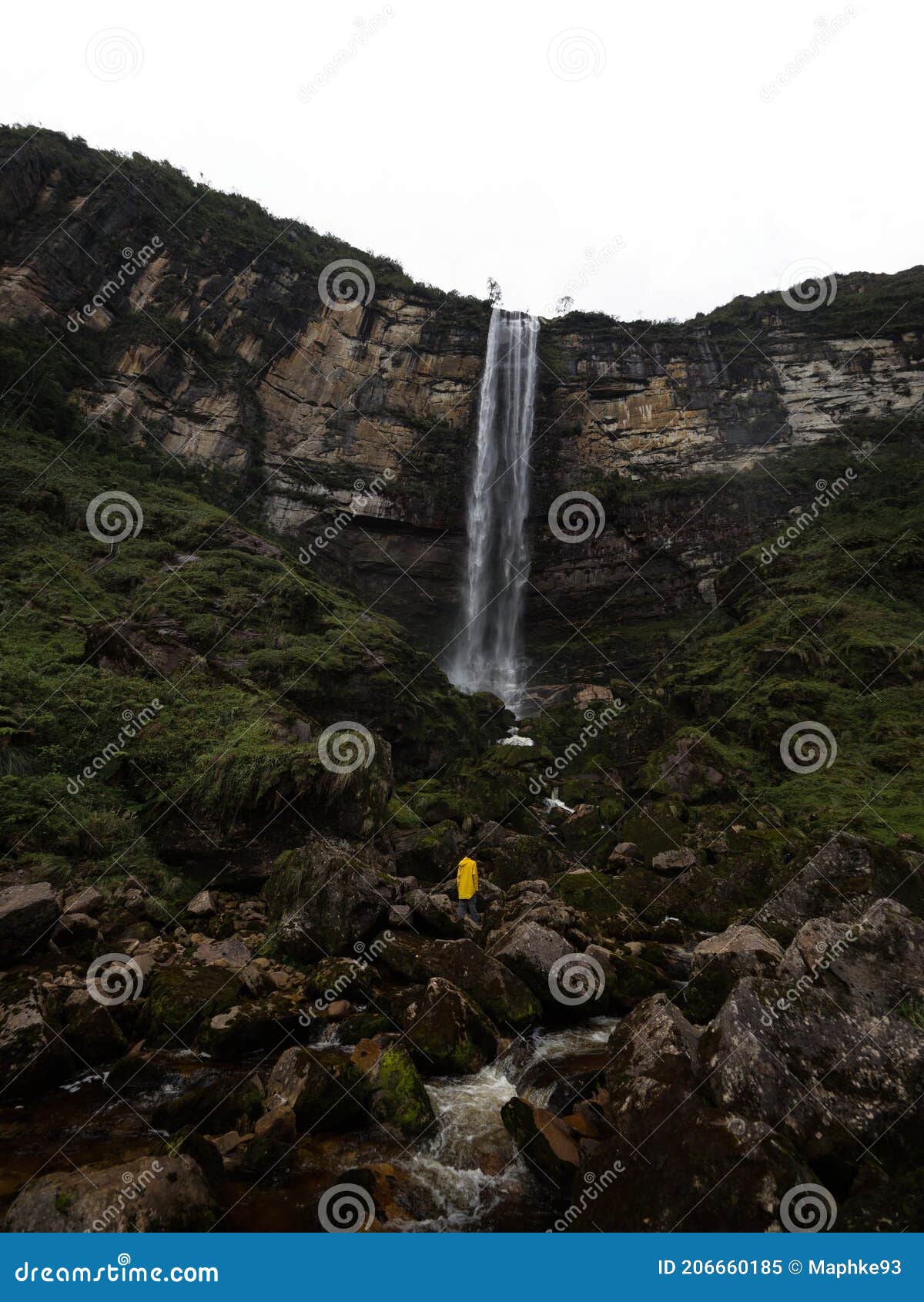 young hiker in yellow jacket at catarata del gocta waterfall cataract cascade in amazonas near chachapoyas in peru andes