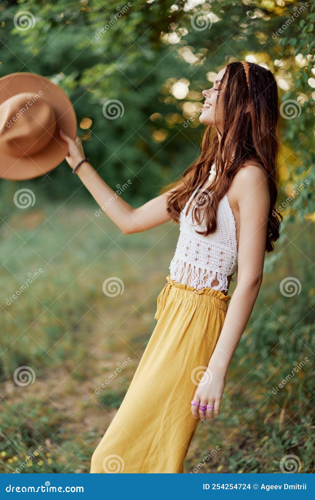 A Young Hippie Woman Dancing Merrily and Smiling Earnestly in Nature in ...