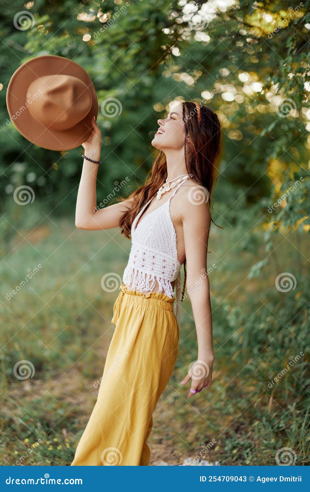A Young Hippie Woman Dancing Merrily and Smiling Earnestly in Nature in ...