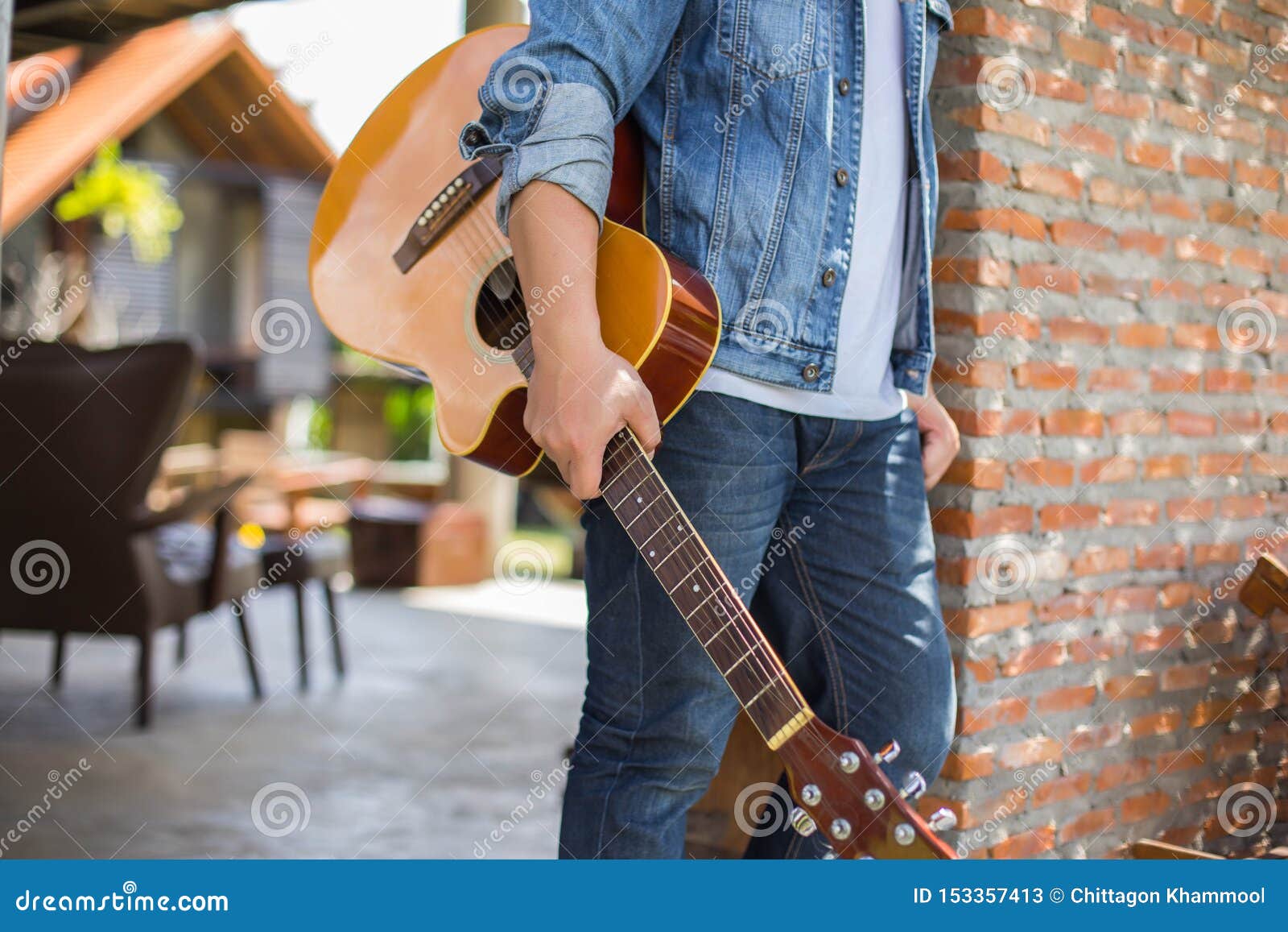 young hipster man practiced guitar in the park,happy and enjoy playing guitar.