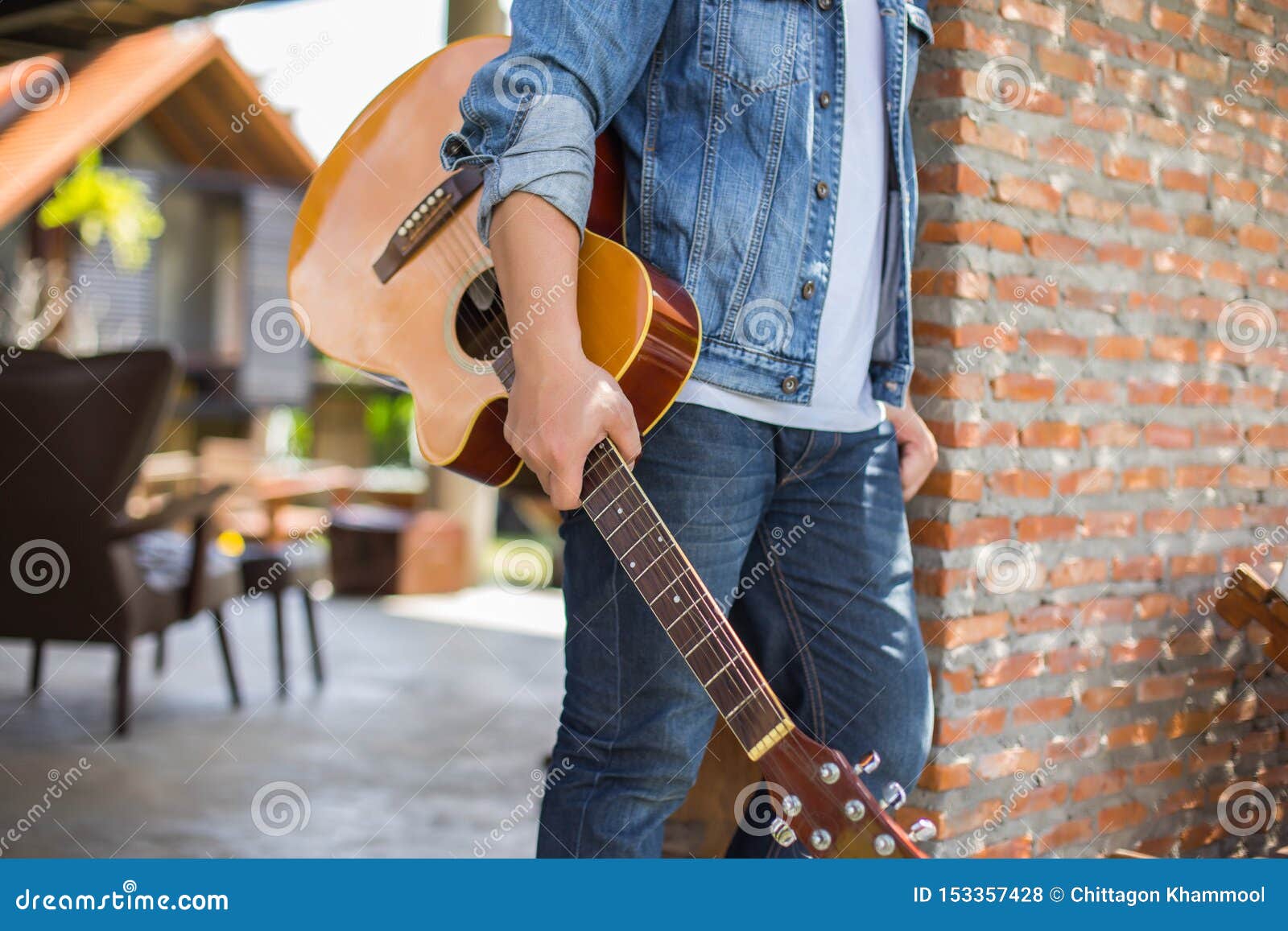 young hipster man practiced guitar in the park,happy and enjoy playing guitar.