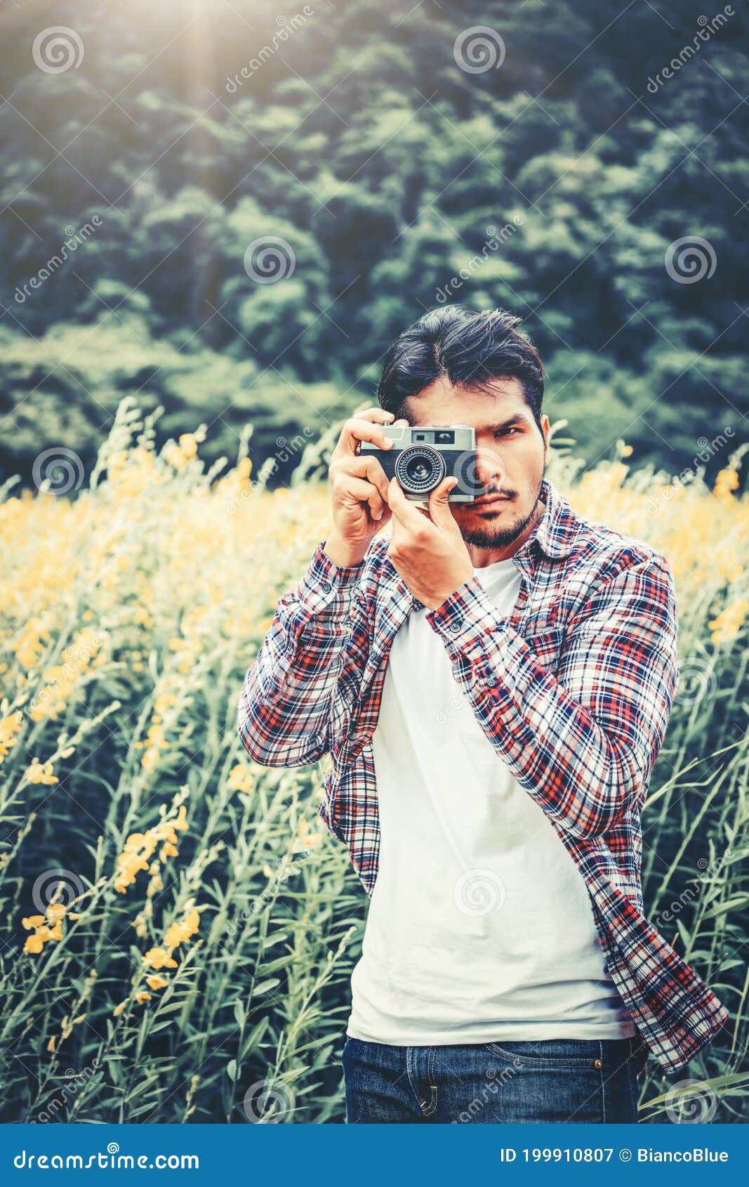 Image of Young Indian Boy Clicking Photos From His Dslr Camera With Blue  Sky In The Background.-AY556981-Picxy