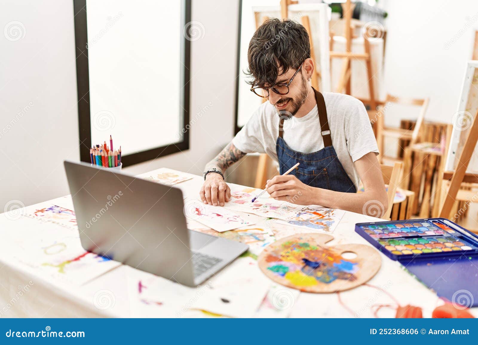 Young Hispanic Artist Man Having Online Paint Class at Art Studio Stock