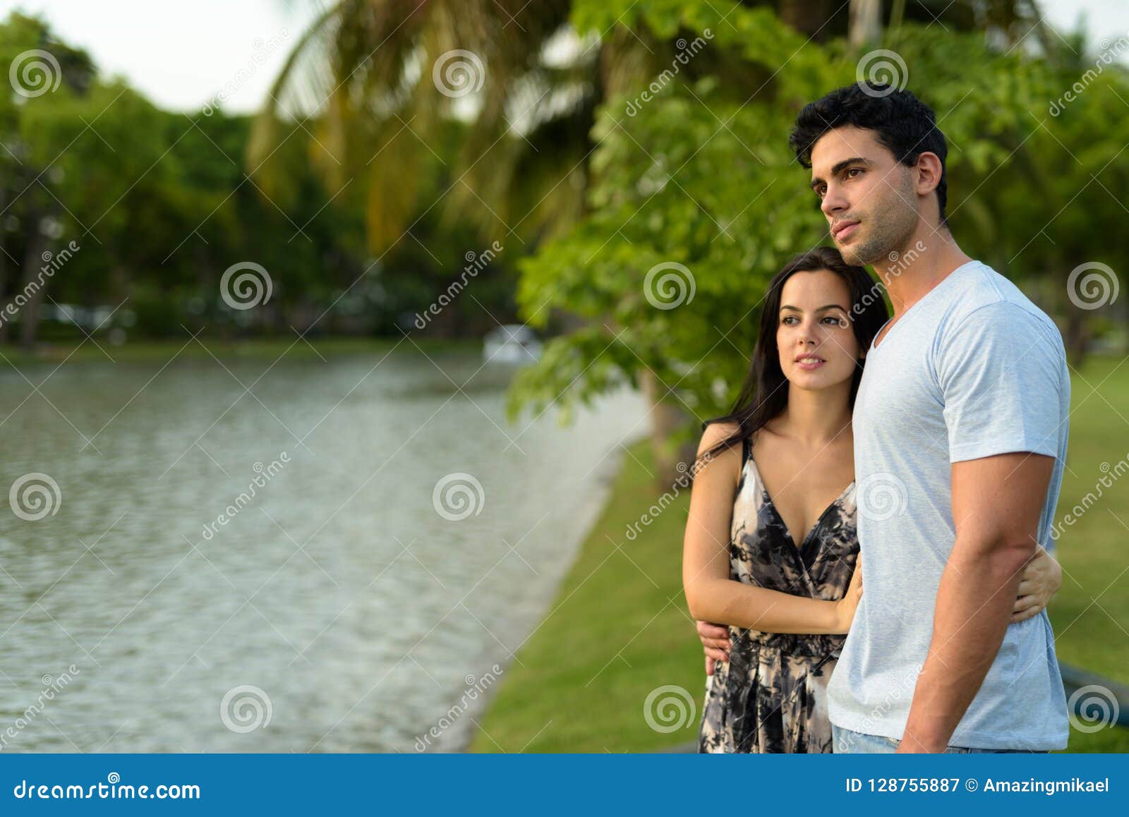 Young Hispanic Couple Relaxing In The Park Together Stock Image Image