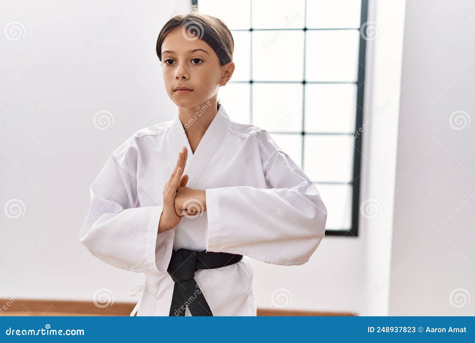 Young Hispanic Girl Doing Martial Arts at Training Studio Stock Image